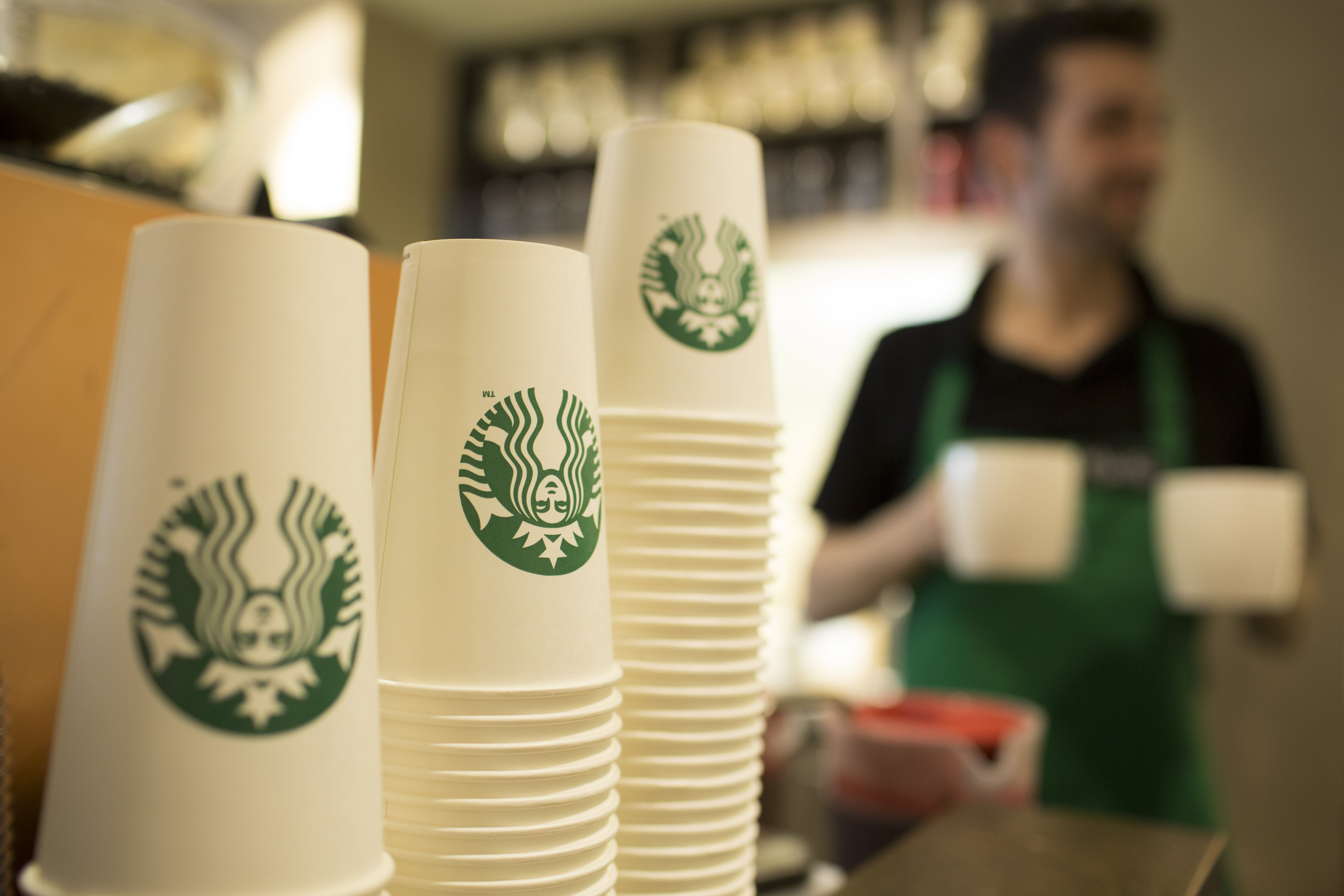 The Starbucks Corp. logo sits on cardboard coffee cups inside a Starbucks Corp. shop in London, U.K., on Monday, June 9, 2014. (Bloomberg via Getty Images)