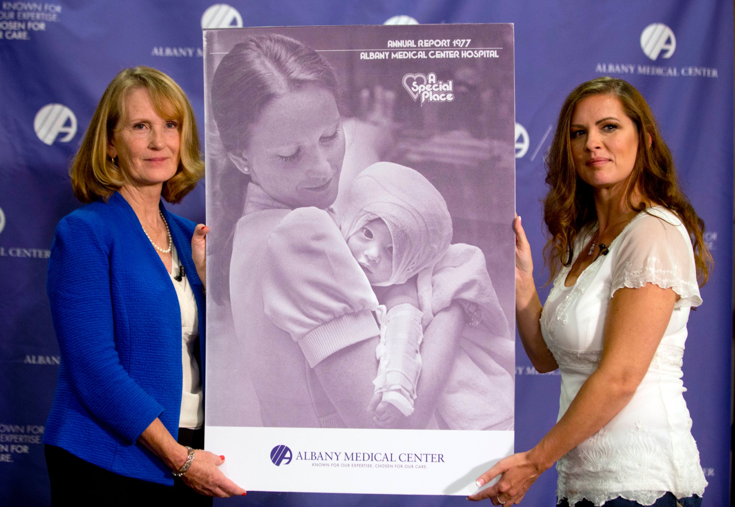Nurse Susan Berger (L) and Amanda Scarpinati pose with a copy of a 1977 Albany Medical Center annual report during a news conference at Albany Medical Center in Albany, N.Y. on Sept. 29, 2015.