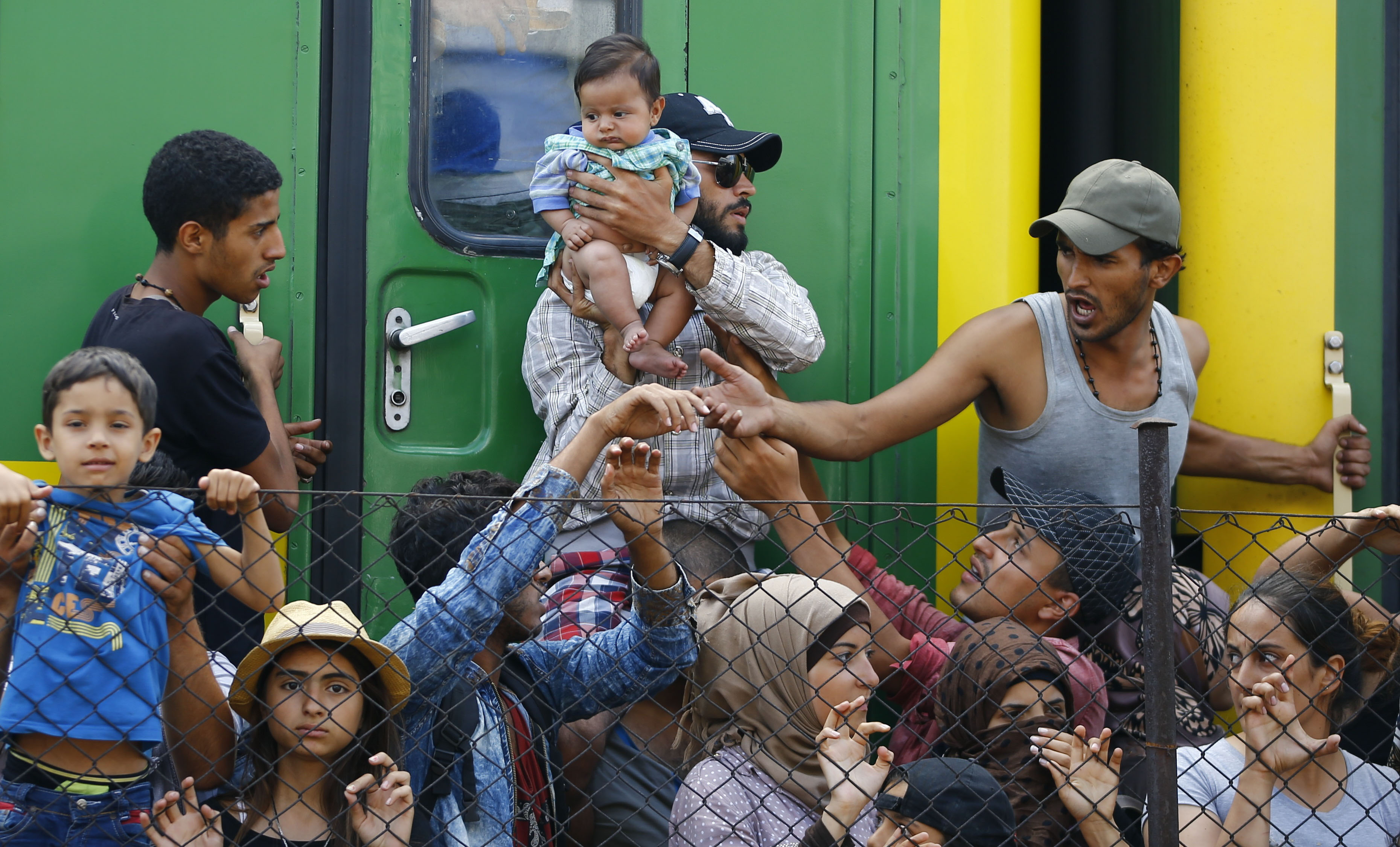 Migrants stand in front of a train at Bicske railway station, Hungary, on Sept. 4, 2015. (Leonhard Foeger—Reuters)