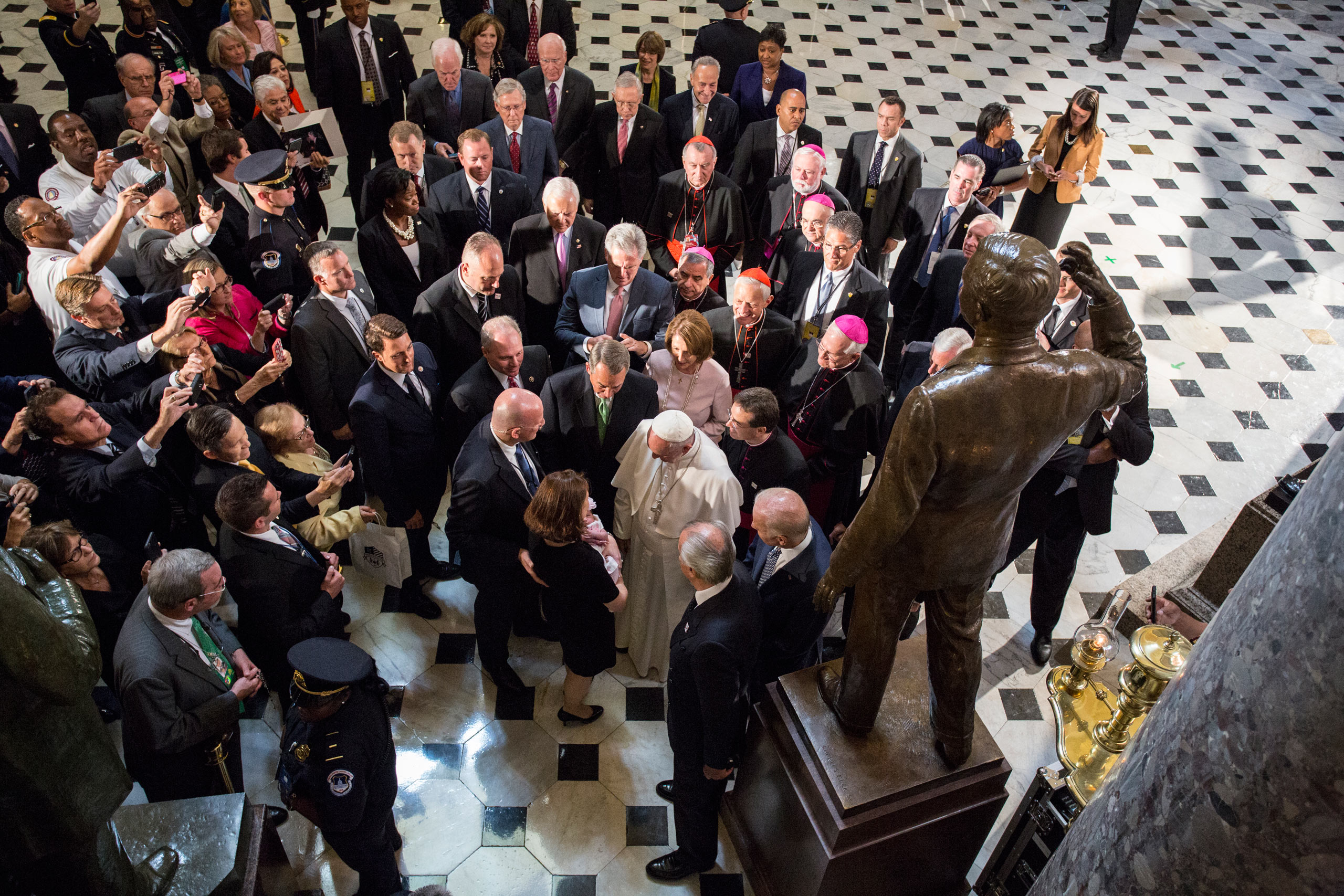 Pope Francis blesses an unidentified child  in Statuary Hall at the U.S. Capitol in Washington, D.C. Sept, 24, 2015.