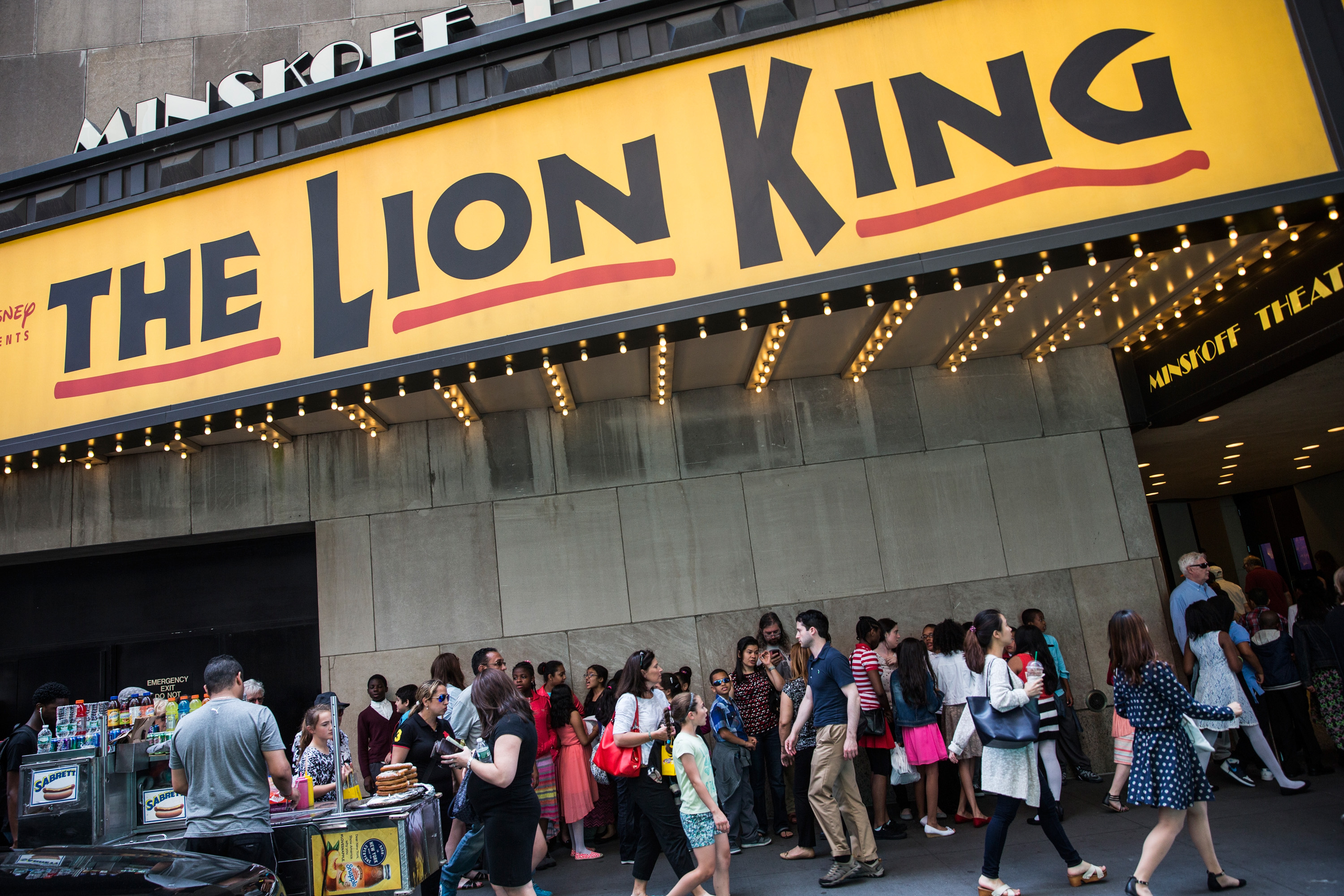 People wait in line to see the matinee show of The Lion King on May 27, 2015 in New York City. (Andrew Burton—Getty Images)