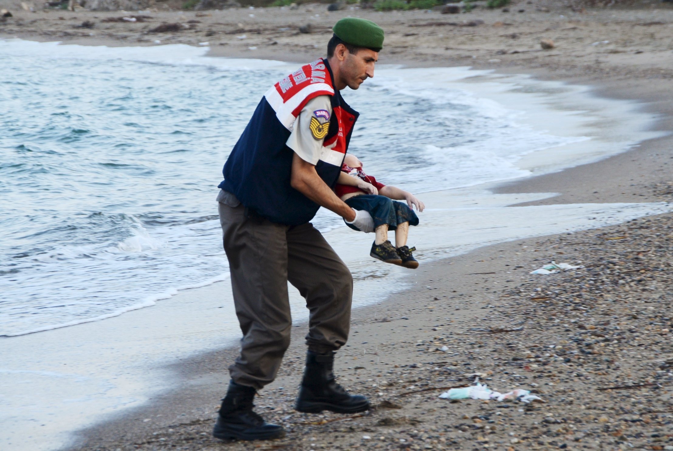 A Turkish gendarme carries the body of Alan Kurdi, 3, who drowned along with his brother Galip, 5, and their mother, in a failed attempt to sail to the Greek island of Kos, in the coastal town of Bodrum, Turkey, on Sept. 2, 2015. (Reuters)