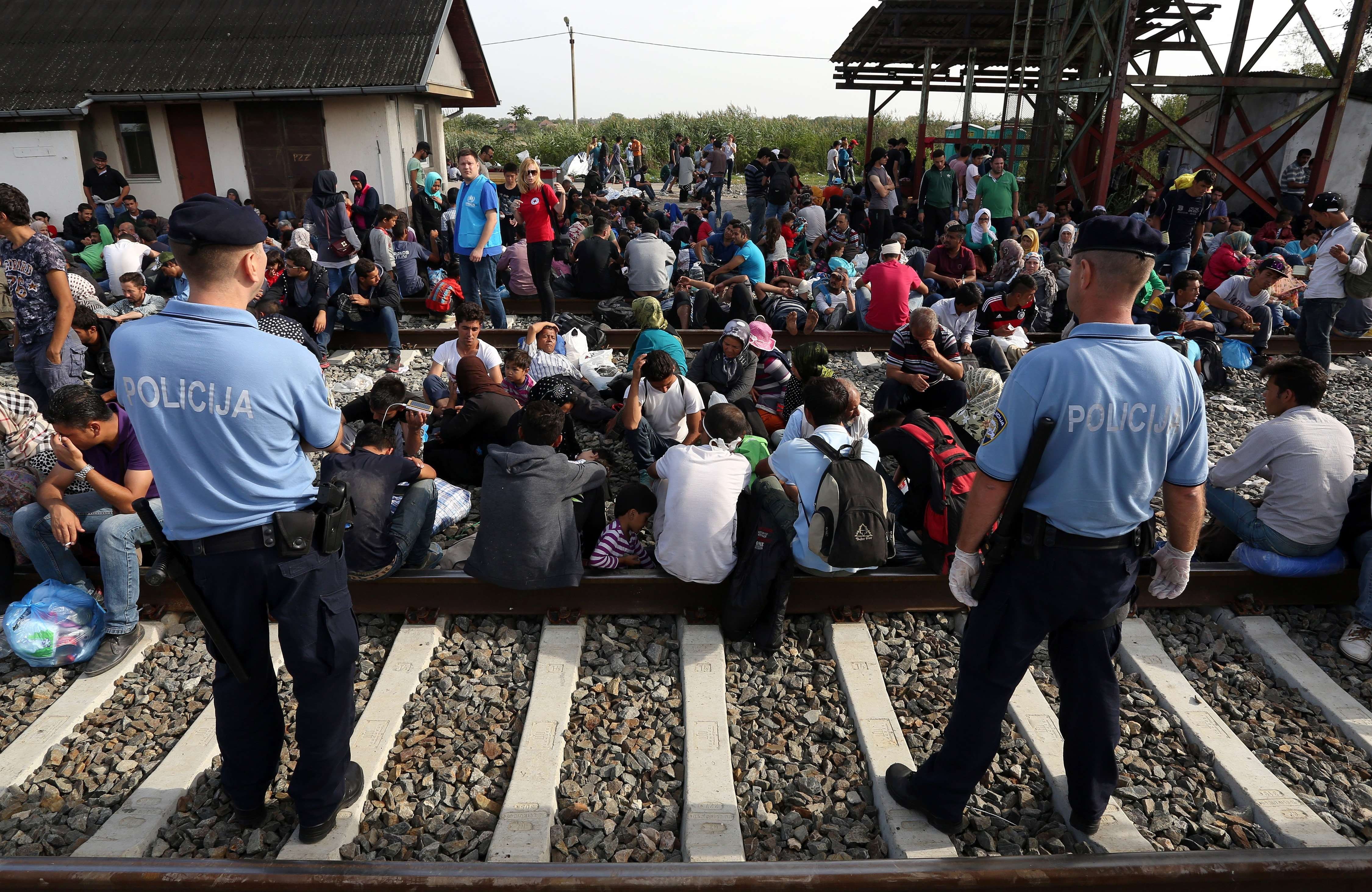 Migrants wait for a train at  a railway station, near the official border  between Serbia and Croatia, near Eastern-Croatian town of Tovarnik, on Sept. 17, 2015. (AFP/Getty Images)