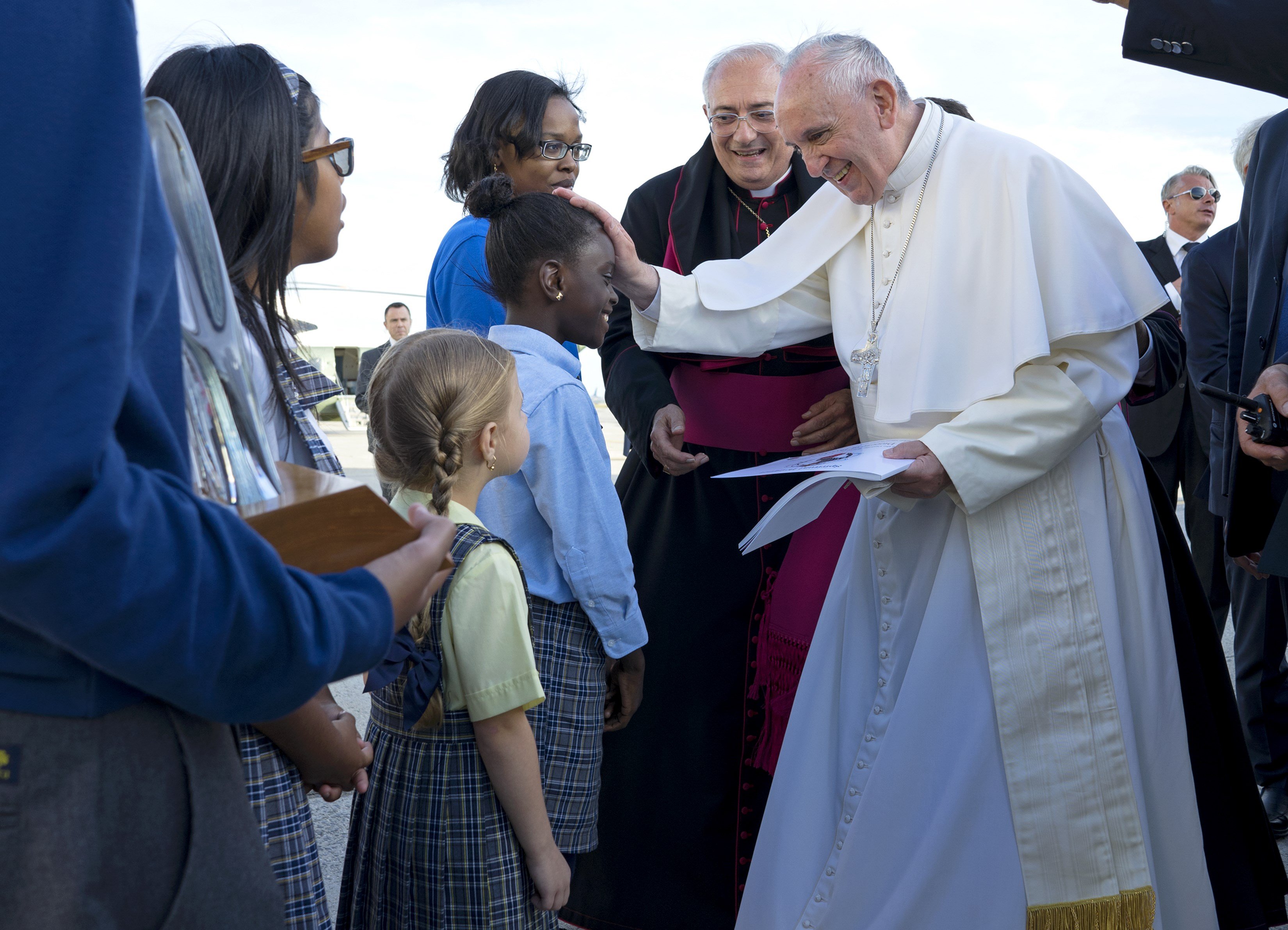 Pope Francis reaches out to 5th grader Omodele Ojo of East New York, Brooklyn as he is greeted as he arrives at John F. Kennedy International Airport on Sept. 24, 2015, in New York.