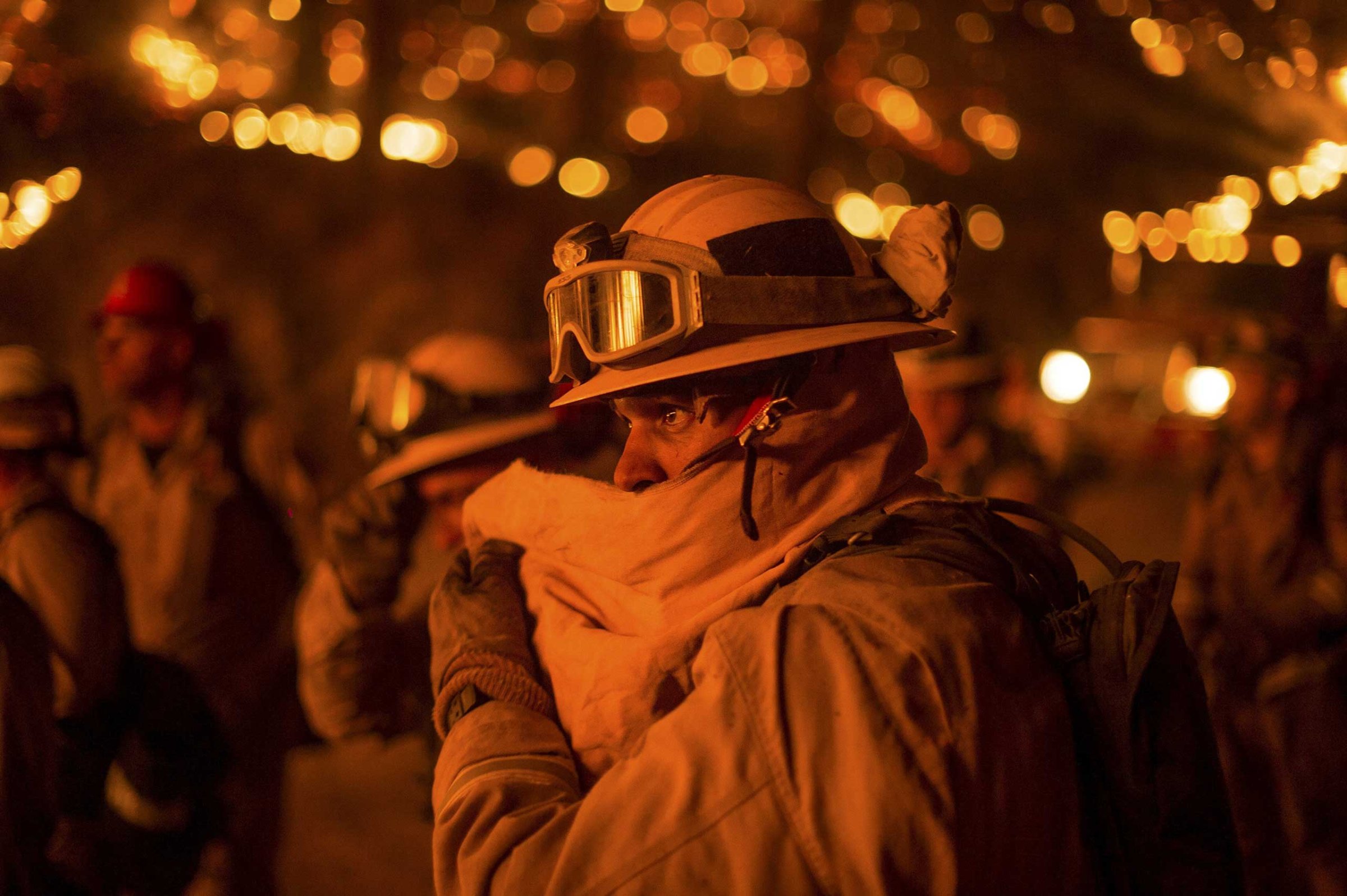 Firefighter covers his face while battling the Butte fire near San Andreas