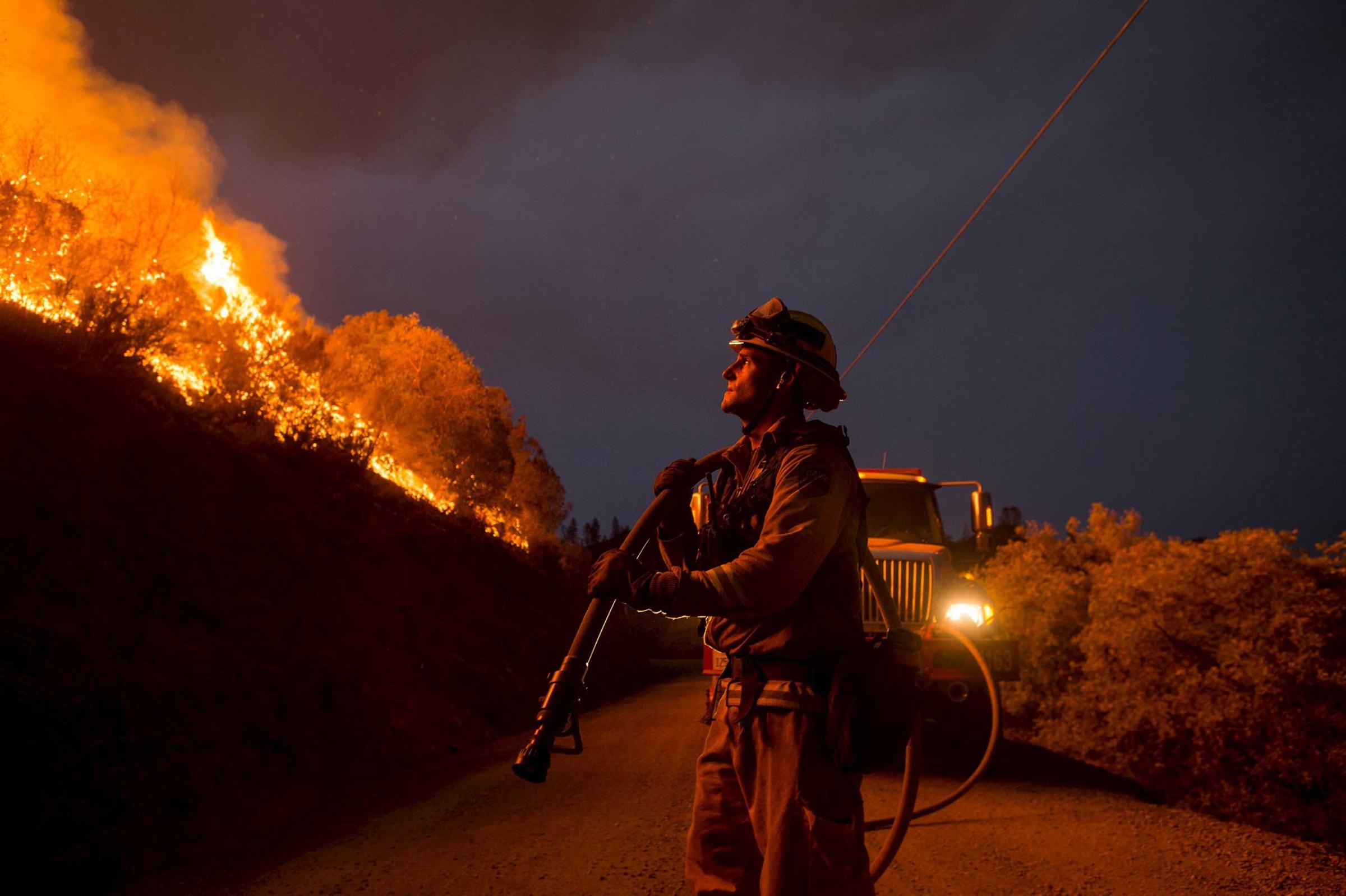 Firefighter Andrew Dodds monitors a backfire while battling the Butte fire near San Andreas