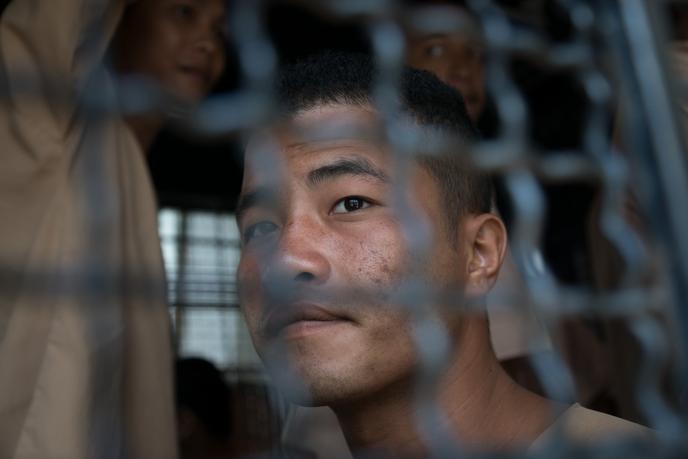 Myanmar national Zaw Lin looks on as he arrives in a prison transport van outside Koh Samui court on the Thai resort island of Koh Samui on July 9, 2015.