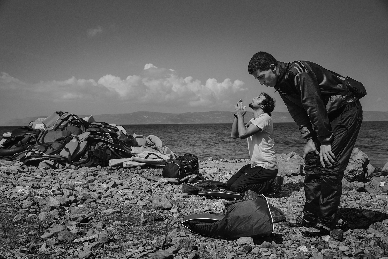 Muslim men pray upon reaching the beach in Lesbos, Greece, Sept. 25, 2015.