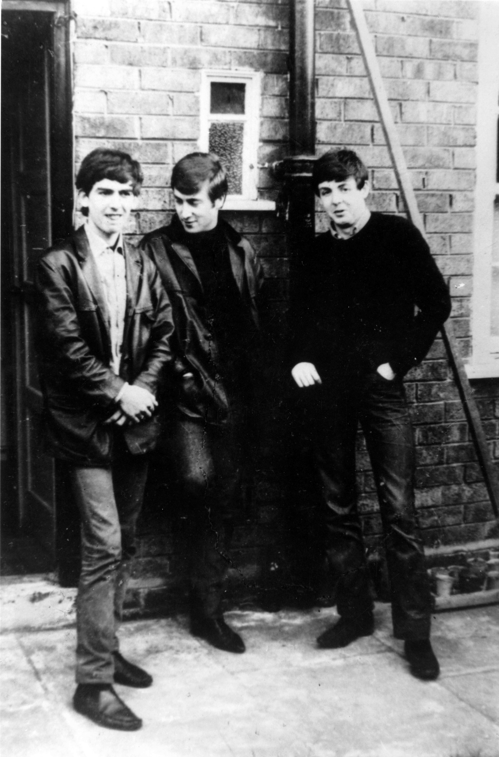 The Beatles standing outside Paul's Liverpool home (left to right) George Harrison (1943 - 2001), John Lennon (1940 - 1980), Paul McCartney. Ringo Starr was not to join the band for another two years. Circa 1960.