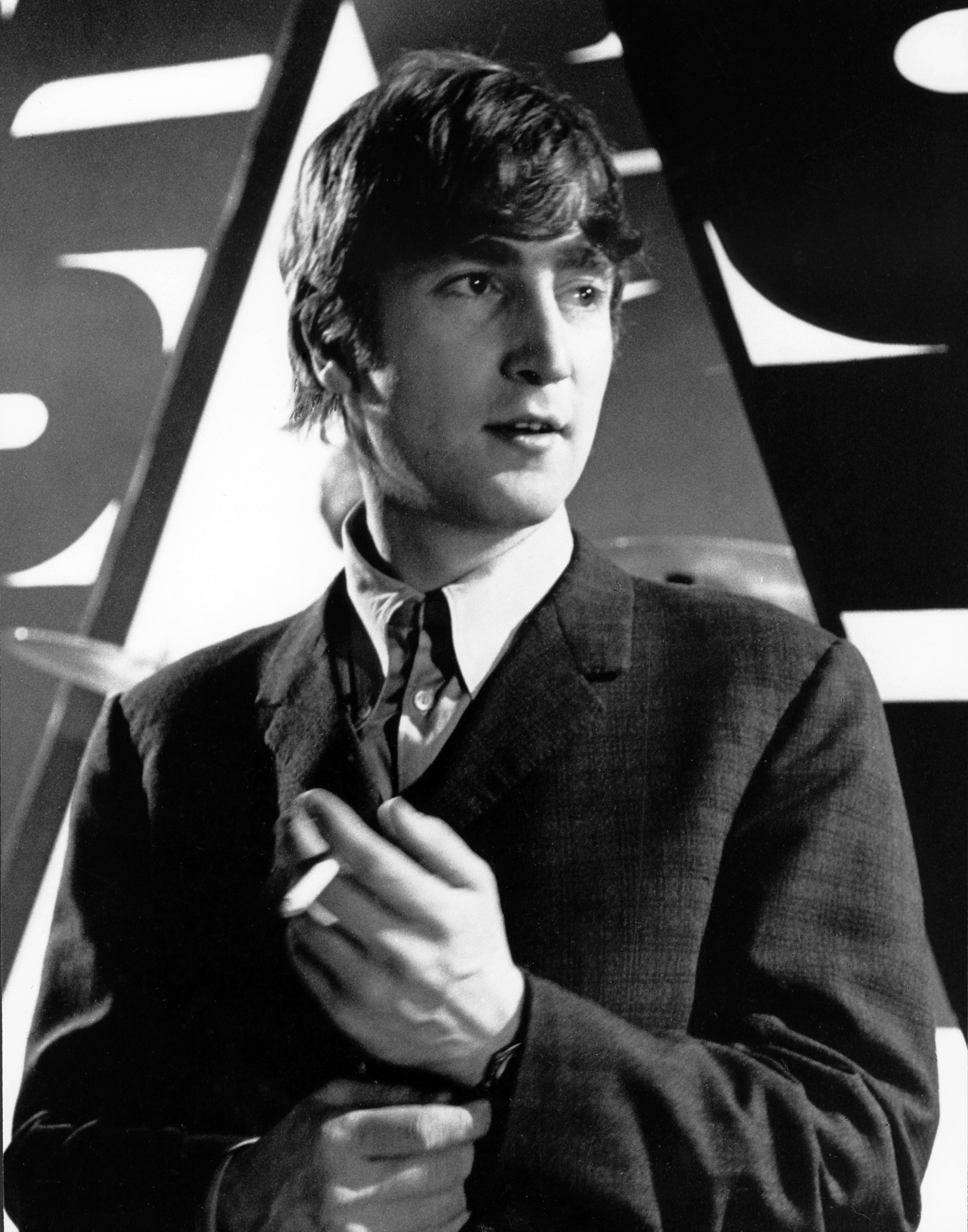 John Lennon, of The Beatles, posed, on set, holding a cigarette at Alpha Television Studios, Aston, Birmingham