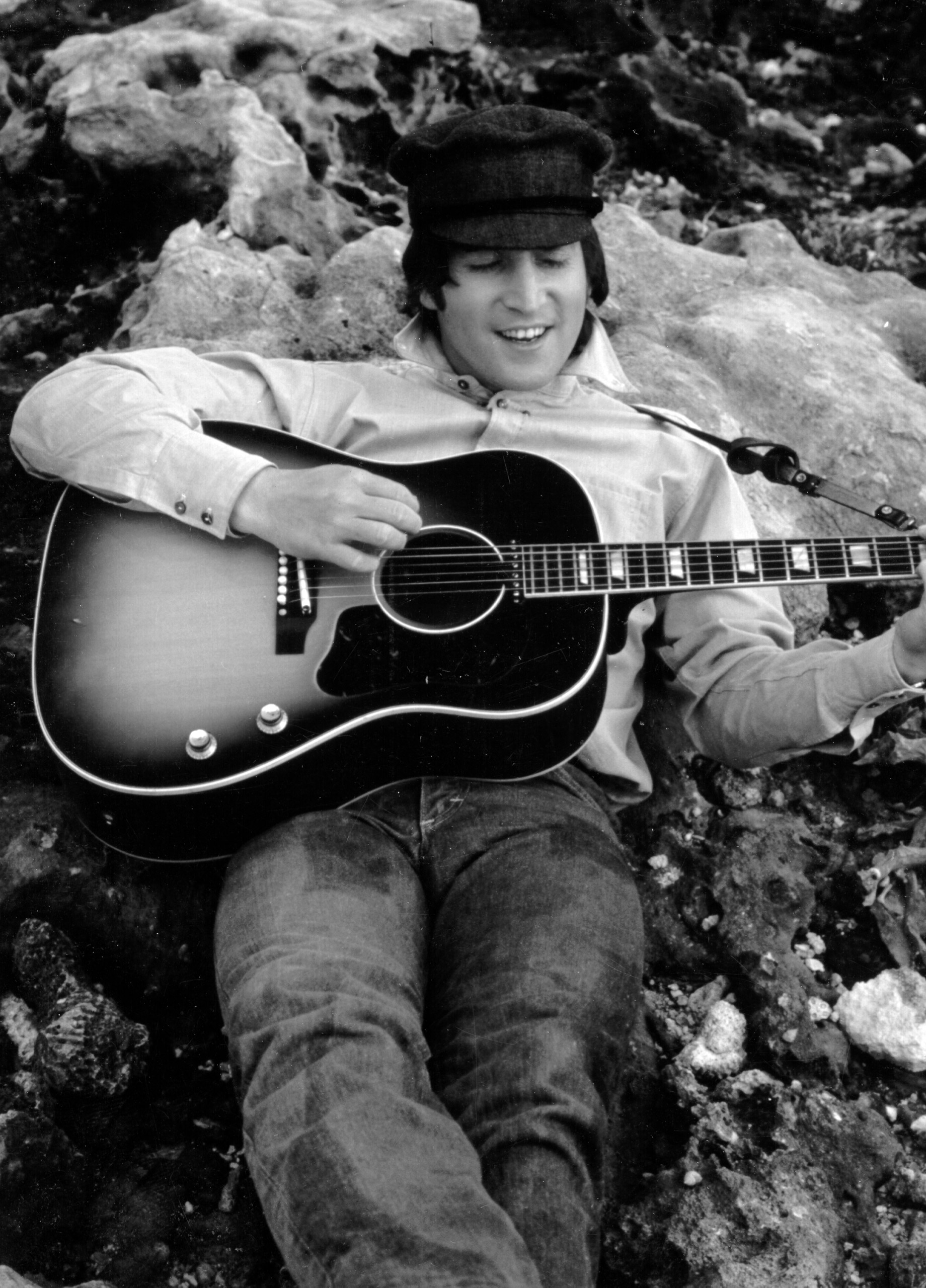 John Lennon playing a Gibson guitar, circa 1964.