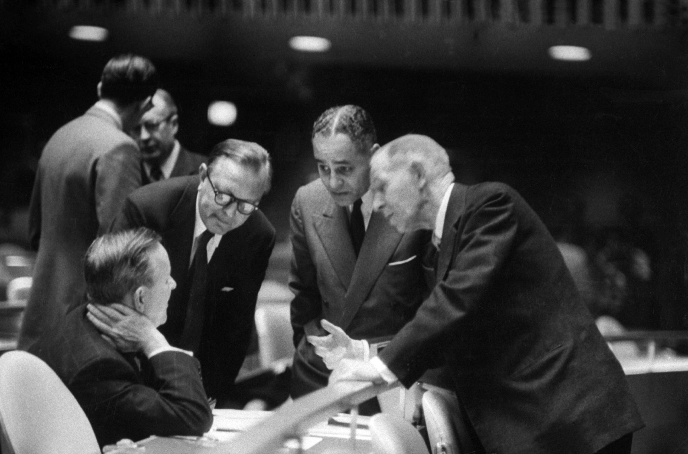 Ralph Bunche (2R) at emergency UN session, 1956.