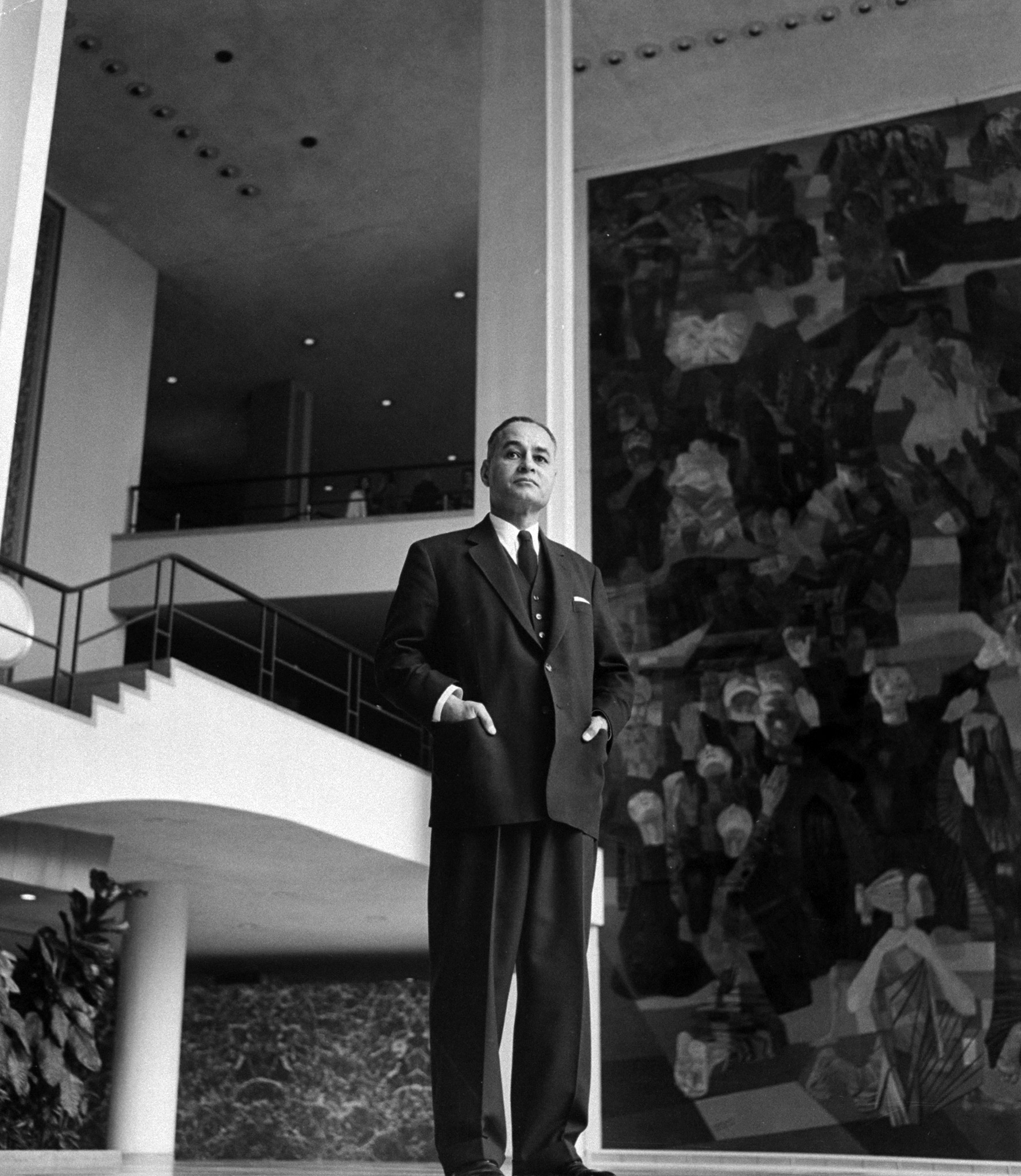 Dr. Ralph Bunche standing in front of the UN building, 1958.