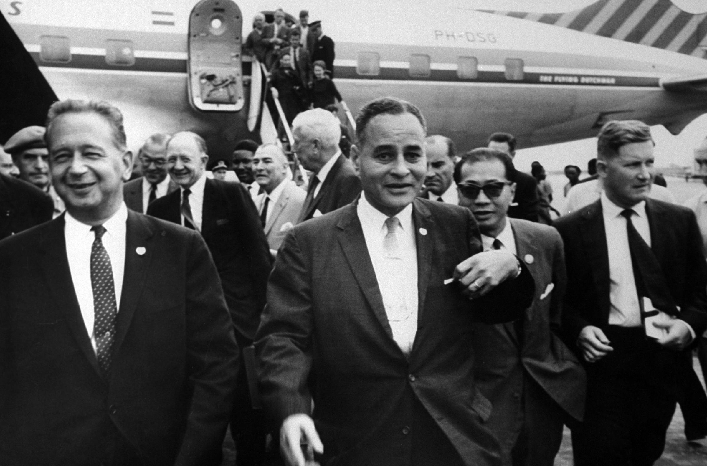 UN Secretary. Dag Hammarskjold (L) and UN Rep. Dr. Ralph J. Bunche (2L) arriving in Leopoldville airport, 1960.