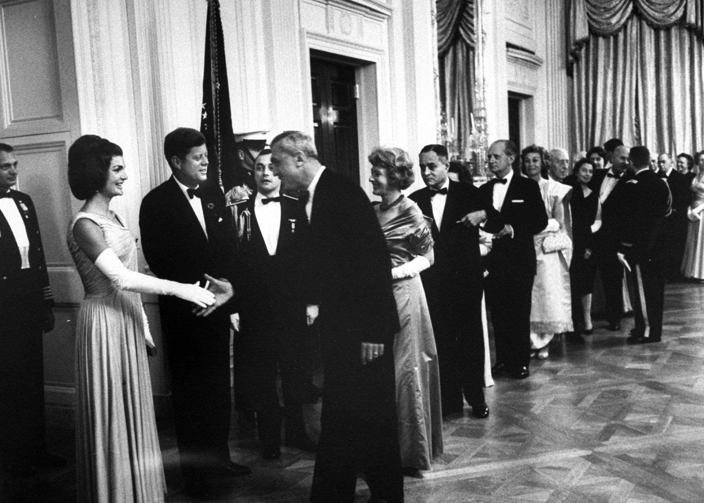 President John F. Kennedy greeting guests at his party for Nobel Prize winners including Ralph Bunche at the White House, 1962.