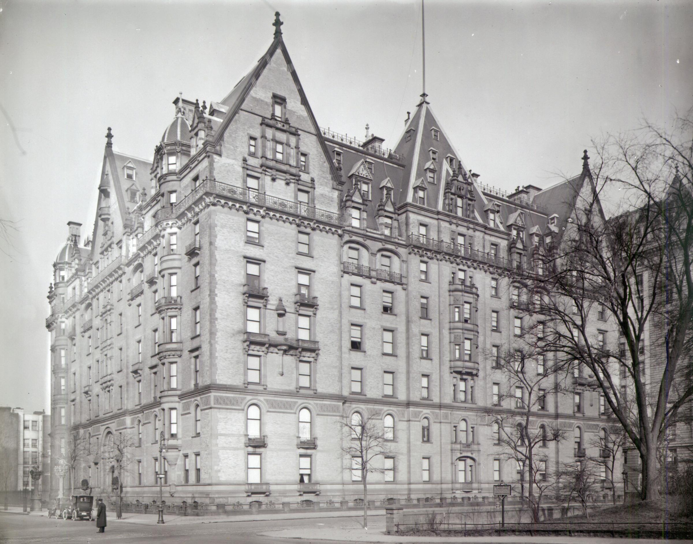 The photograph can be dated to about 1910 by the automobiles at the curb, and by the presence of the Langham Apartments at 135 Central Park West between 73rd and 74th Streets, which was completed in 1906. The sentry box for the guard has been replaced by a sign that warns visitors that “Any Person Taking Flowers or Leaves or defacing shrubbery in any Portion of the Park will be detained or Arrested and Punished.” The central gable on 72nd Street has now gained another small dormer window, and the south side of the central gable on Central Park West has single one near the top as well.