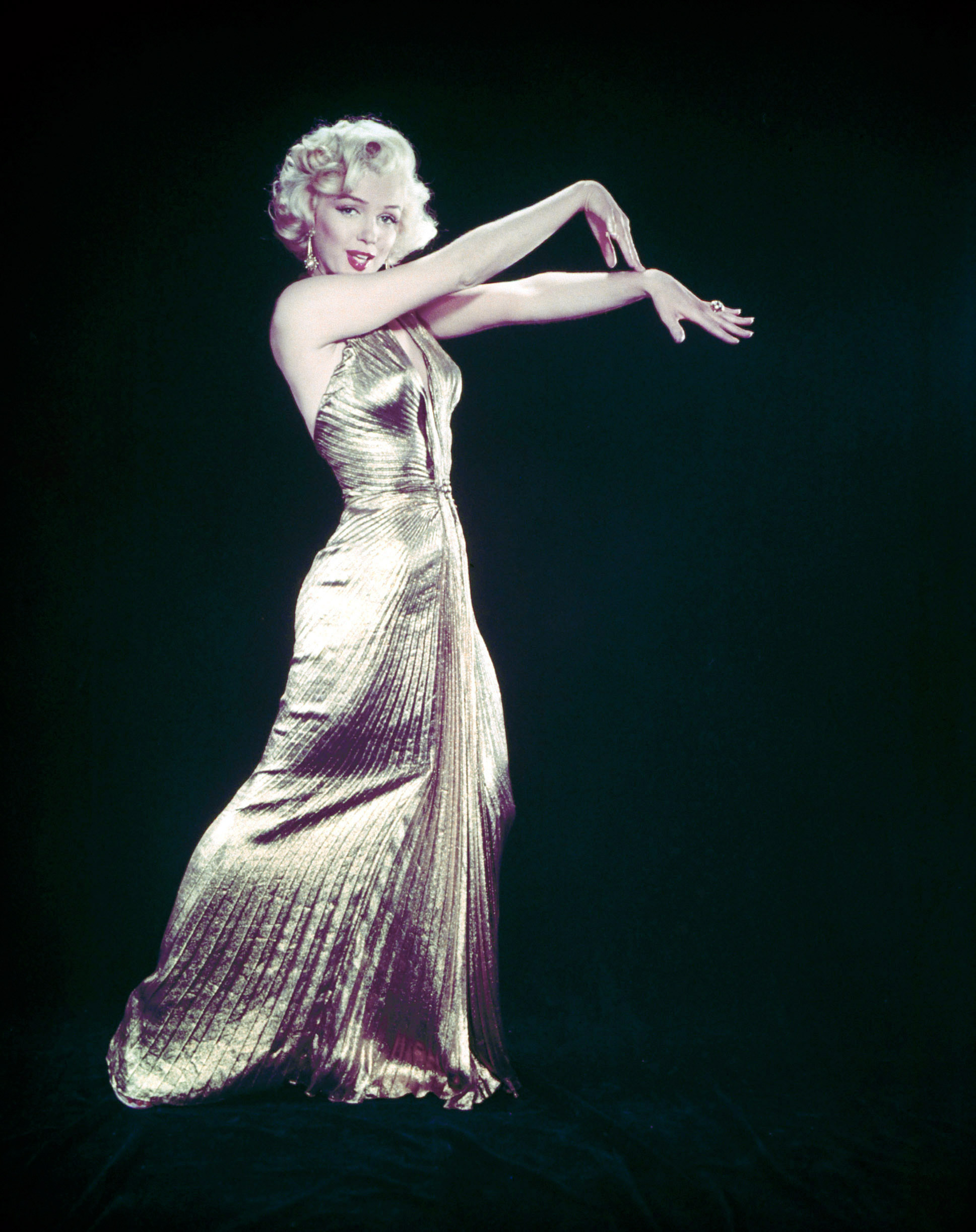 Actress Marilyn Monroe posing wearing her famous gold lame gown for the motion picture "Gentlemen Prefer Blondes."