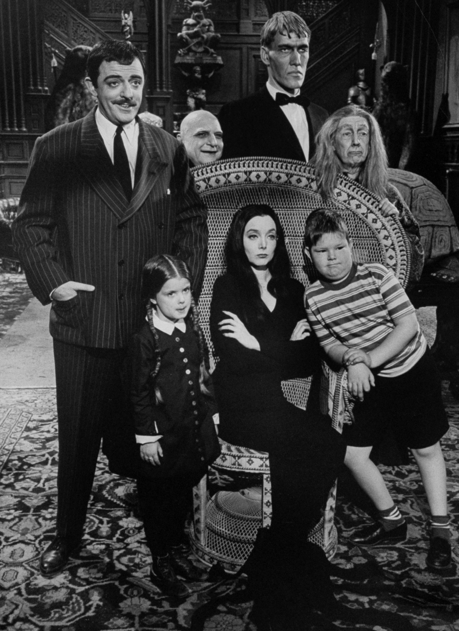 Carolyn Jones and John Astin, with other cast members, from The Addams Family.