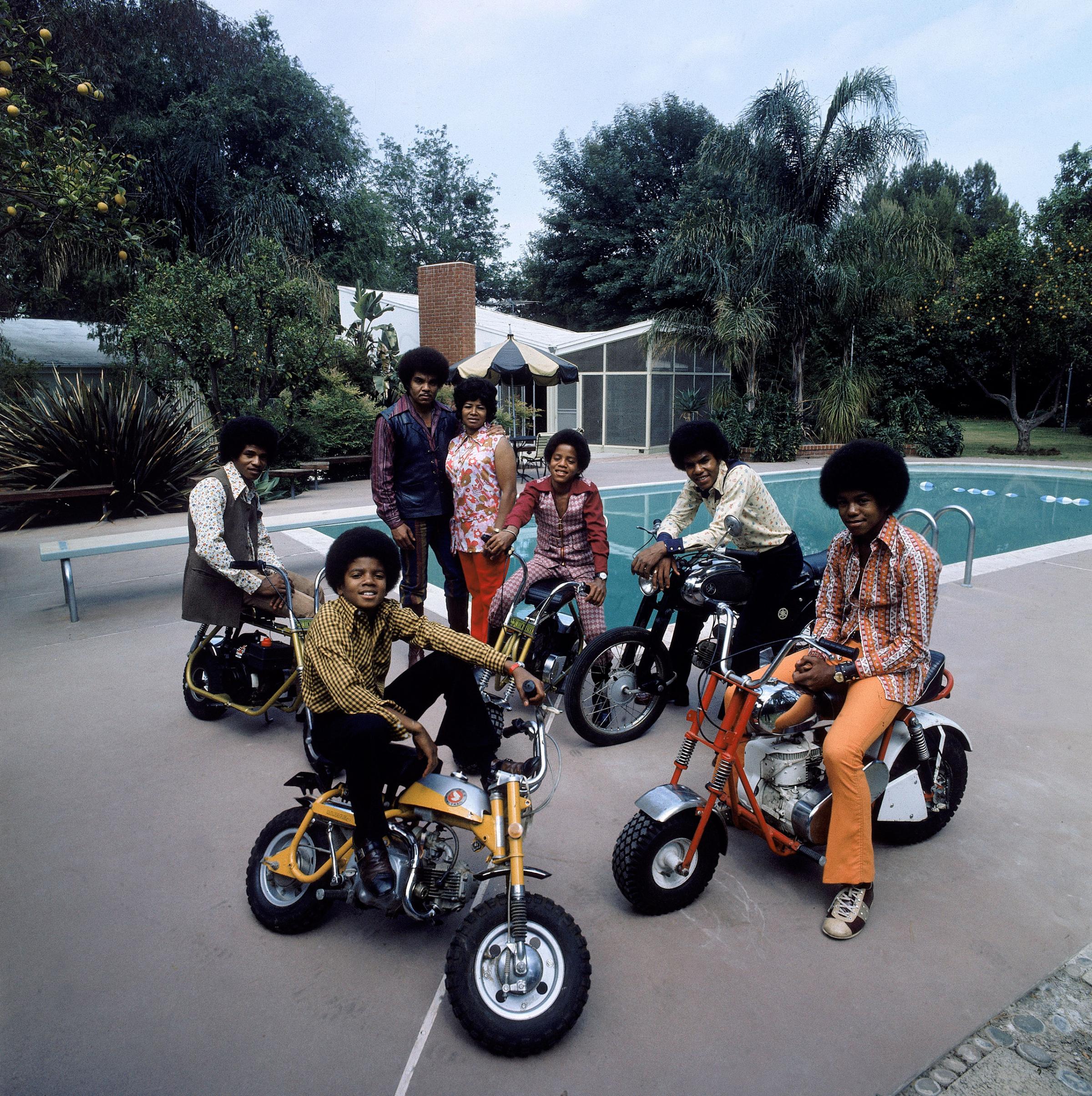 Members of pop group Jackson Five (clockwise L-R): Jackie, parents Joe and Katherine, Marlon, Tito, Jermaine and Michael in their backyard.
