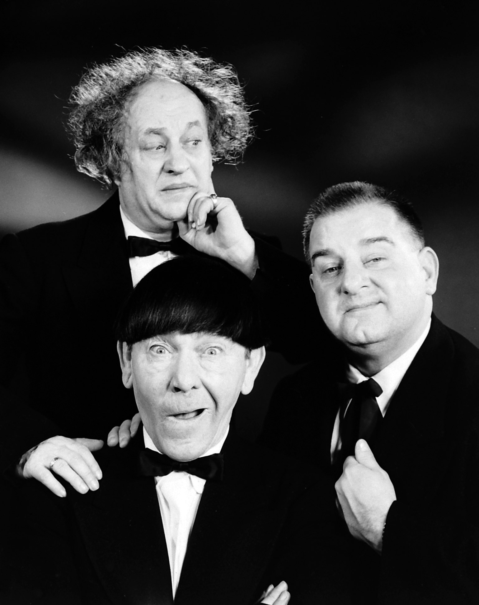 Comedy group The Three Stooges (clockwise from L): Curly Joe DeRita, Moe Howard, Larry Fine.