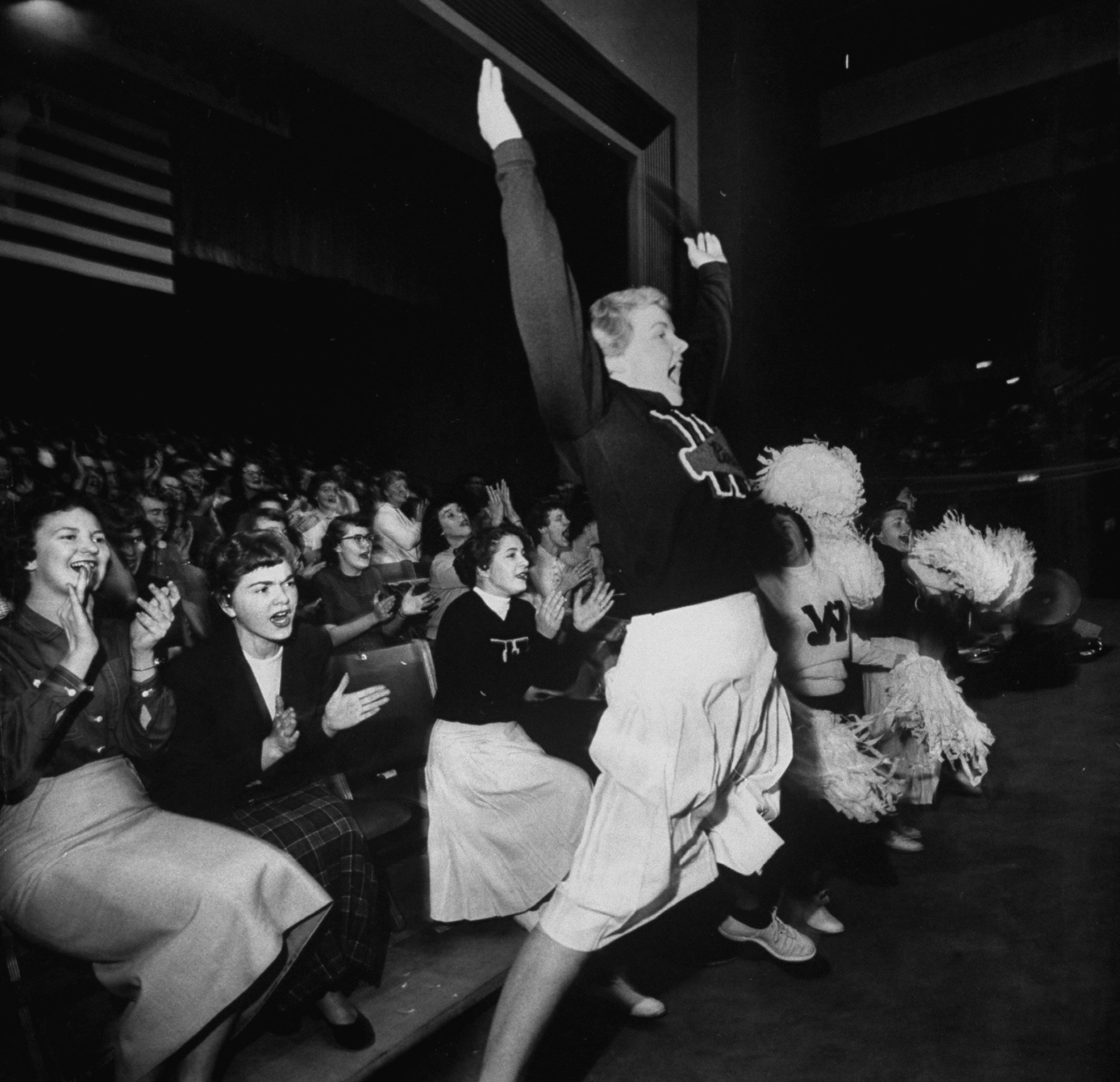 Cheering section of cheerleaders in Spokane Coliseum, 1954.