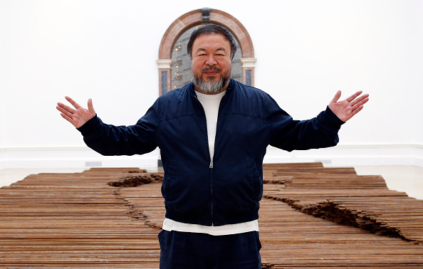 Ai Weiwei stands with his sculpture <i>Straight</i> as he previews works from his landmark art exhibition on Sept. 15, 2015, in London (Alex B. Huckle—Getty Images)