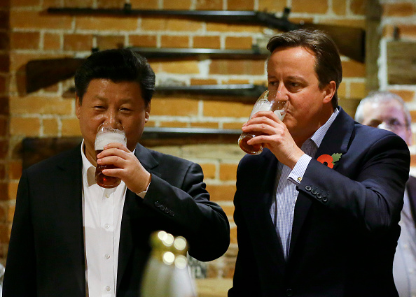 China's President Xi Jinping and Britain's Prime Minister David Cameron drink a pint of beer during a visit to the the Plough pub on Oct. 22, 2015, in Princes Risborough, England (Kirsty Wigglesworth—WPA Pool/Getty Images)