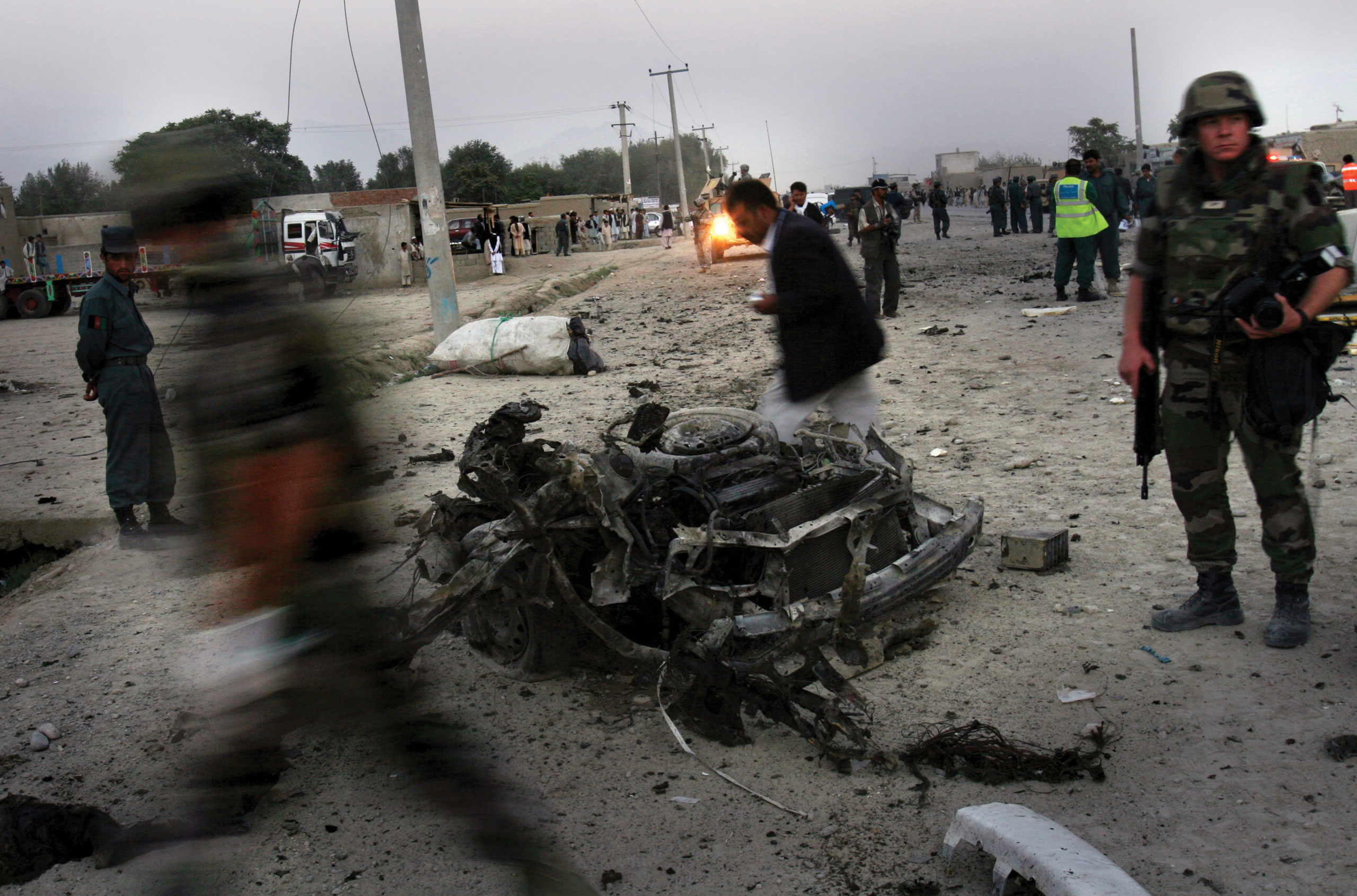 French soldiers arrive to the scene where a suicide car bomber killed three Afghan policemen and wounded five people in Kabul, Afghanistan, on Sept. 18, 2006.
