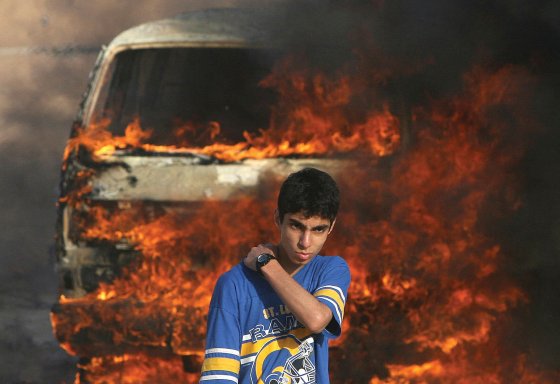 A Palestinian youth stands in front of a