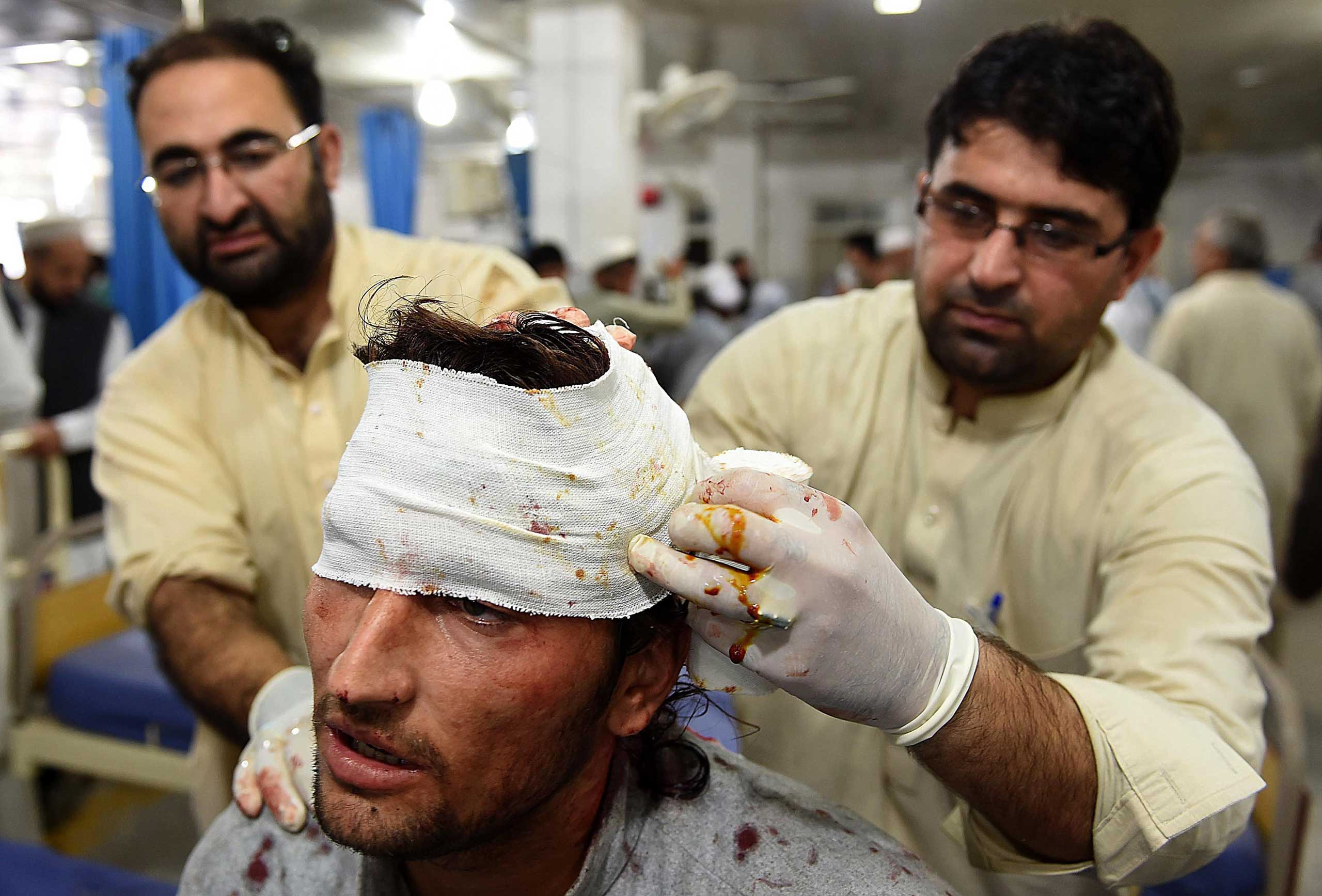 Paramedics treat a man injured in an earthquake at a hospital in Peshawar, Pakistan, on Oct. 26, 2015.