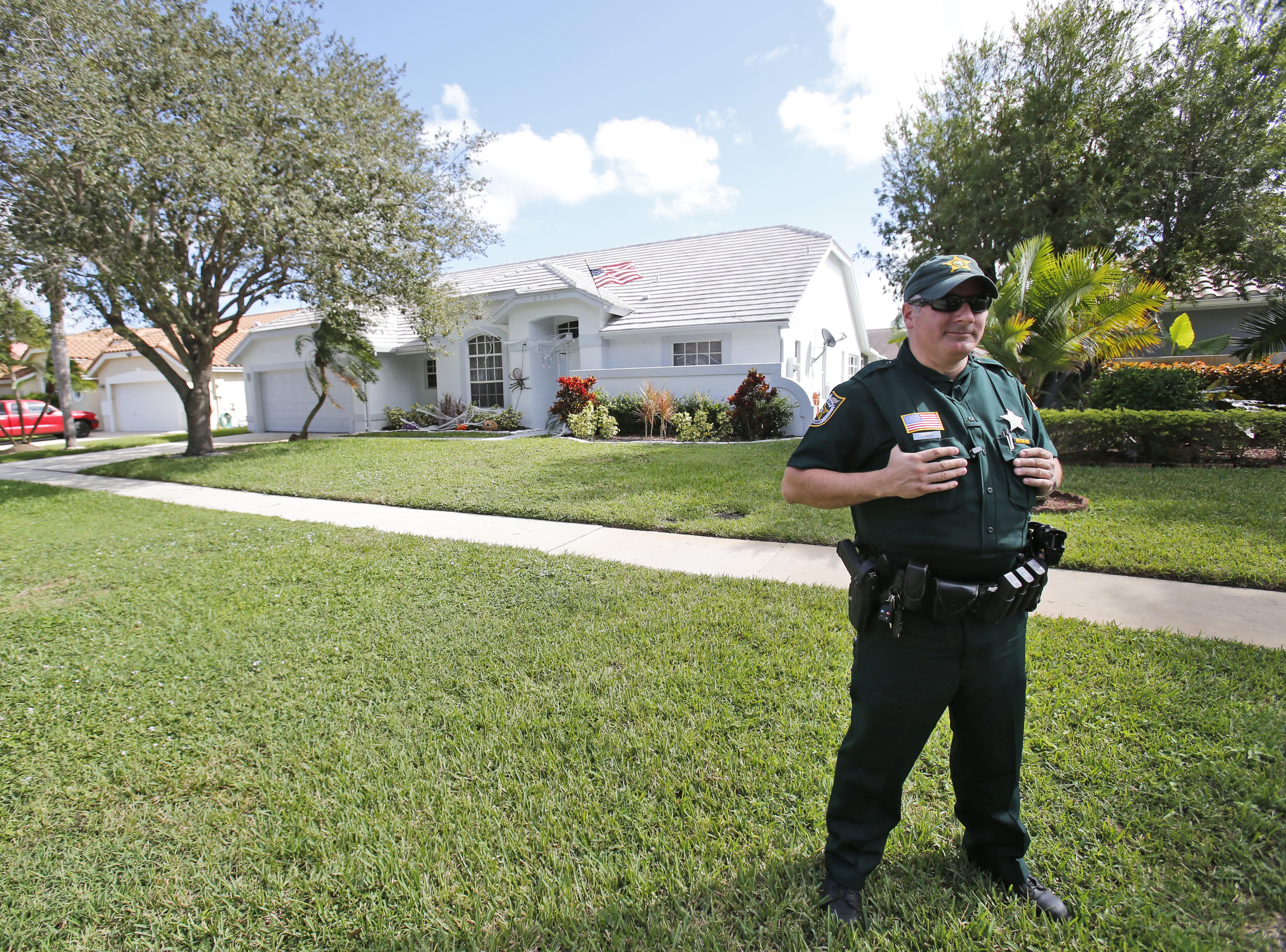 A Palm Beach County Sheriff's deputy keeps watch over the home of Palm Beach Gardens police Officer Nouman Raja, in Lake Worth, Fla., on Oct. 21. 2015. (Wilfredo Lee—AP)