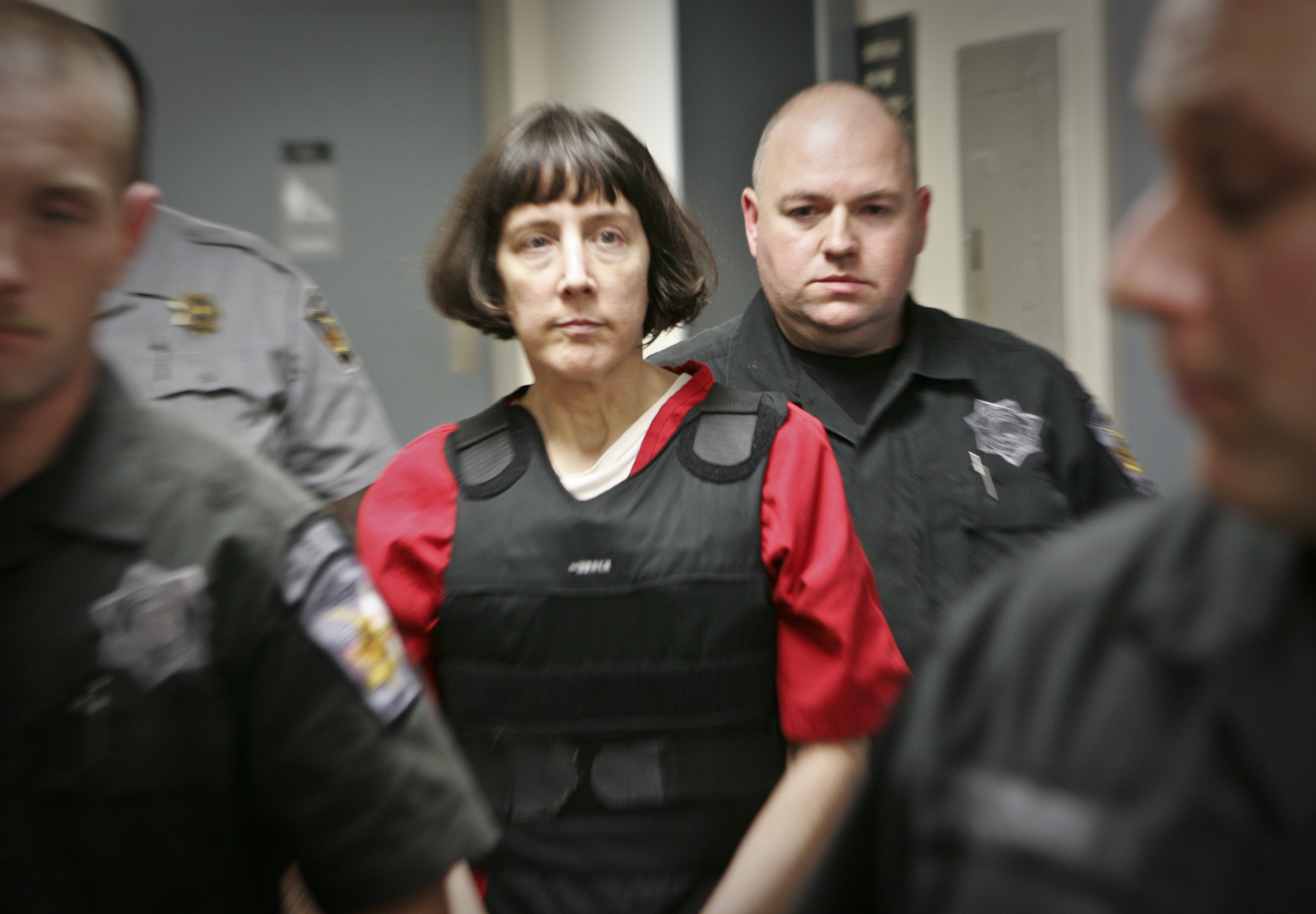 Amy Bishop is escorted by sheriff's deputies at the Madison County Courthouse in Hunstville, Ala., Tuesday, Sept. 11, 2012 (Michael Mercier—AP)