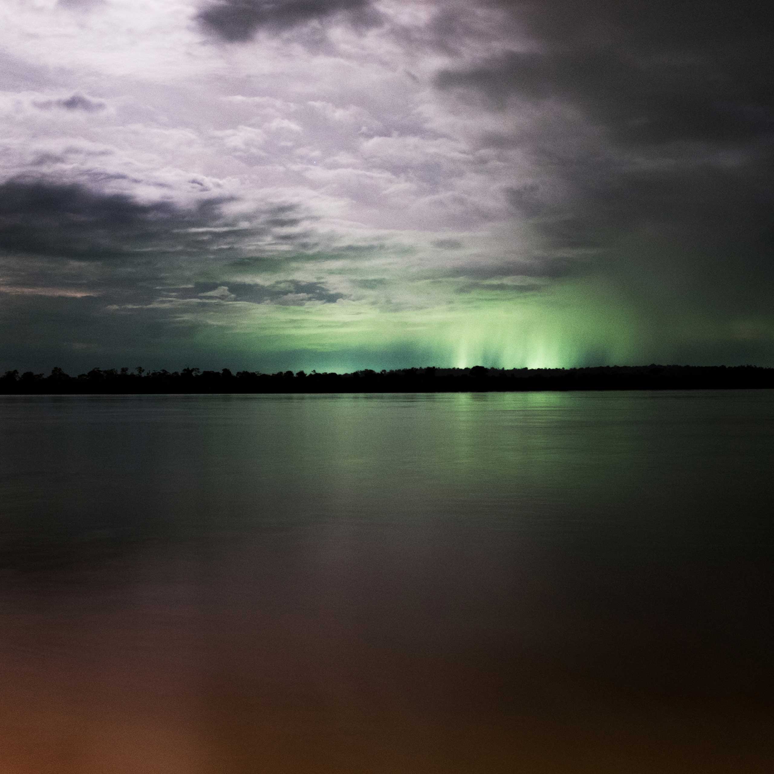 The construction site of the Belo Monte Dam lights up the sky over the Xingu River, seen from the nearby city of Altamira. Belo Monte is the largest industrial operation in South America and will be the third largest dam in the world, Feb. 2014.