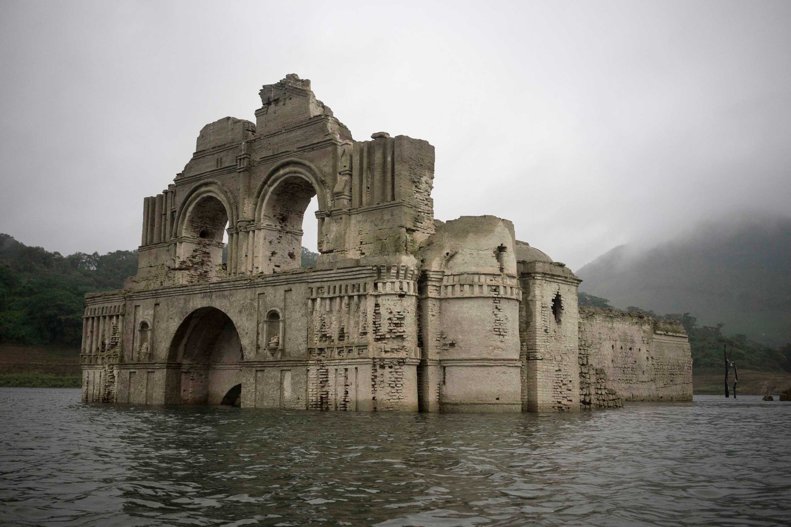 The remains of a mid-16th century church known as the Temple of Santiago, as well as the Temple of Quechula, is visible from the surface of the Grijalva River, which feeds the Nezahualcoyotl reservoir, due to the lack of rain near the town of Nueva Quechula, in Chiapas state, Mexico, Oct. 16, 2015. (David von Blohn—AP)