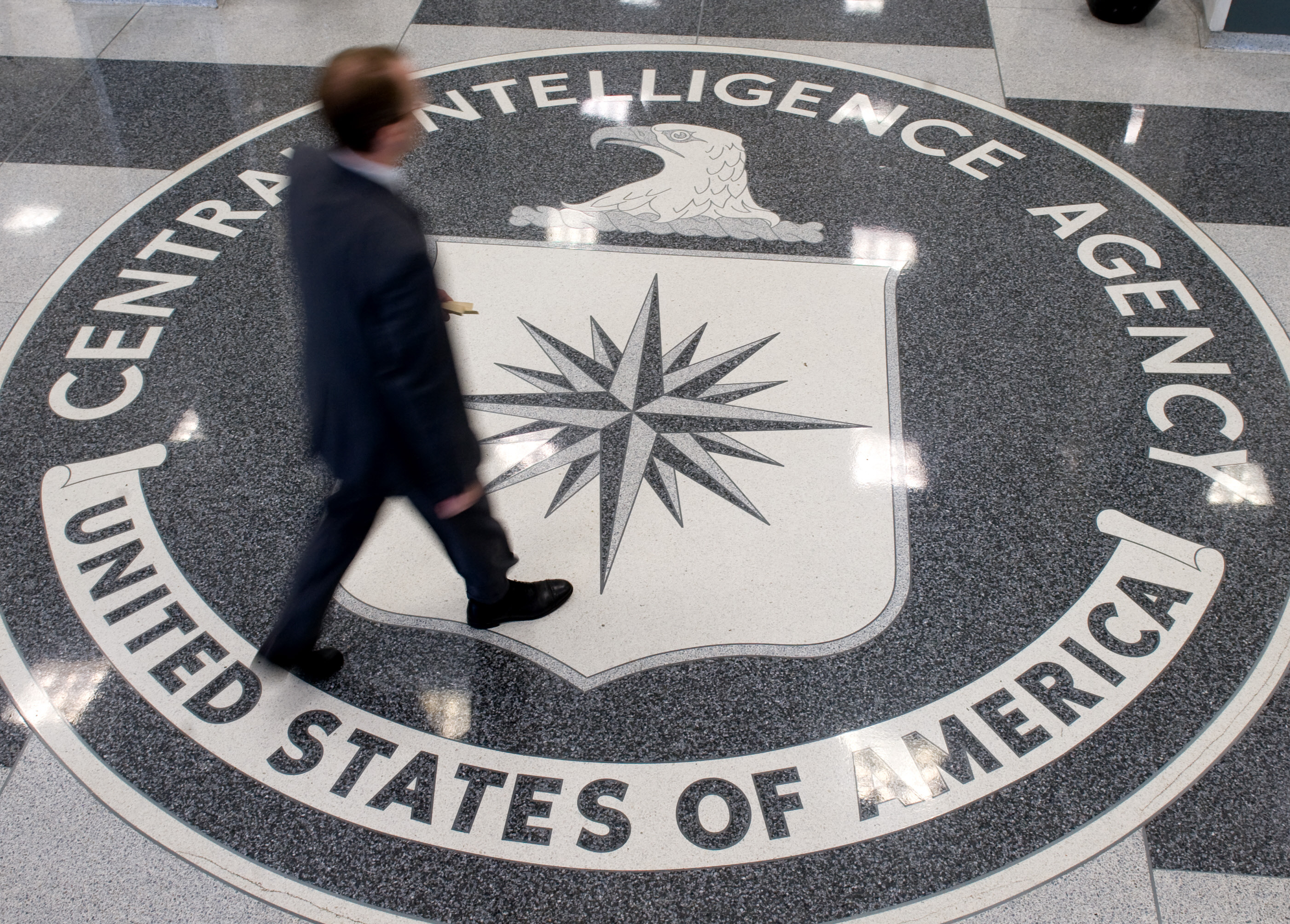 A man crosses the Central Intelligence Agency (CIA) logo in the lobby of CIA Headquarters in Langley, Virginia, on August 14, 2008. (SAUL LOEB&mdash;AFP/Getty Images)
