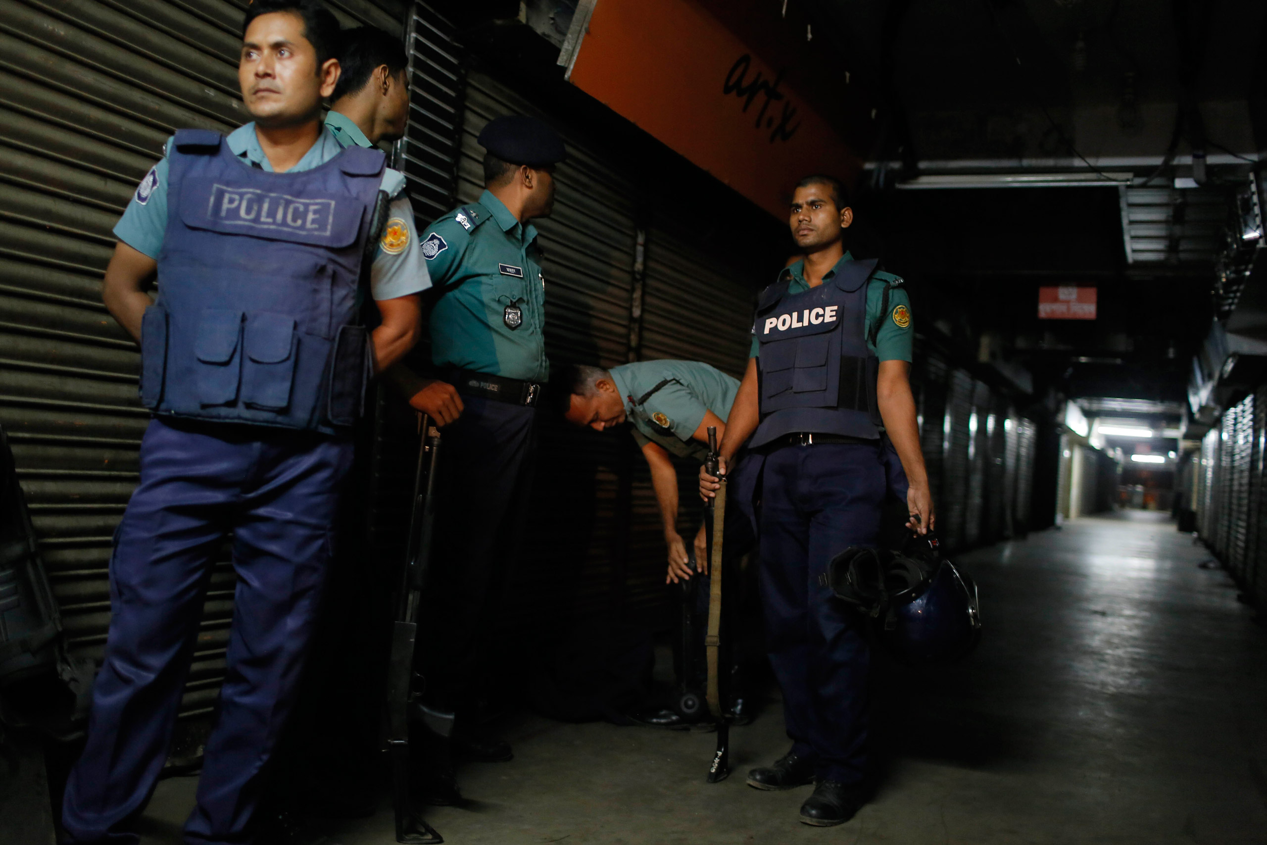 Bangladeshi security officers stand guard at the site where the slaughtered body of Faisal Arefin Deepan was found in Dhaka, Bangladesh, Saturday, Oct. 31, 2015. The publisher of secular books was hacked to death and three other people were wounded in two separate attacks Saturday at publishing houses in Bangladesh's capital, police said. Both of the publishers involved in Saturday's attacks had published works of Bangladeshi-American blogger and writer Avijit Roy, who was hacked to death on the Dhaka University campus while walking with his wife in February. (AP Photo/A.M. Ahad)