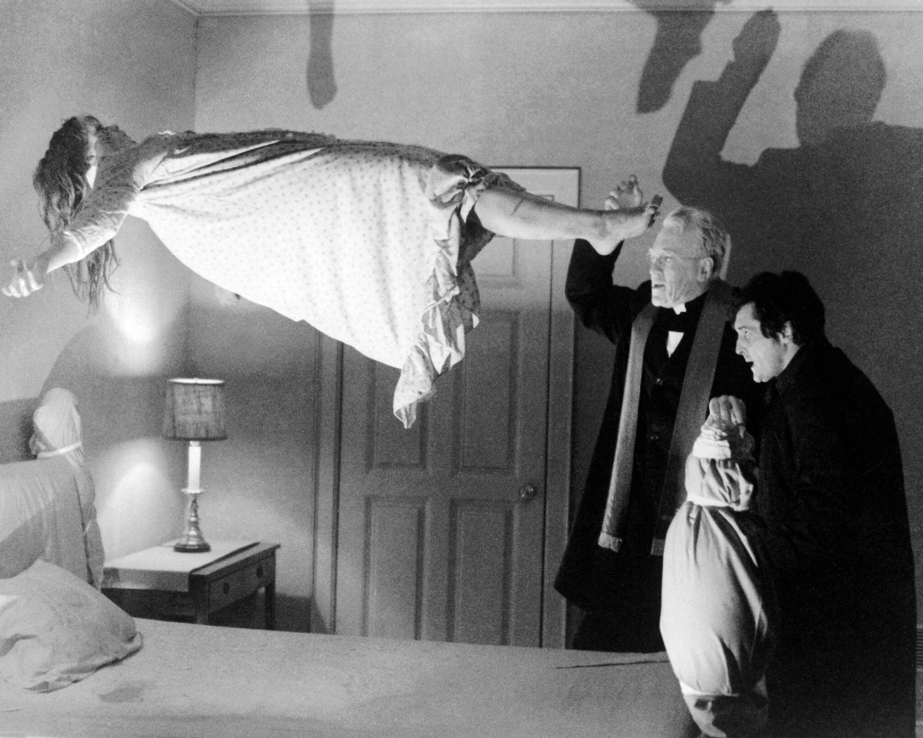 Linda Blair as Regan MacNeil, Max von Sydow as Father Merrin, and Jason Miller as Father Karras in <i>The Exorcist</i>, directed by William Friedkin, 1973. (Silver Screen Collection/;Getty Images)