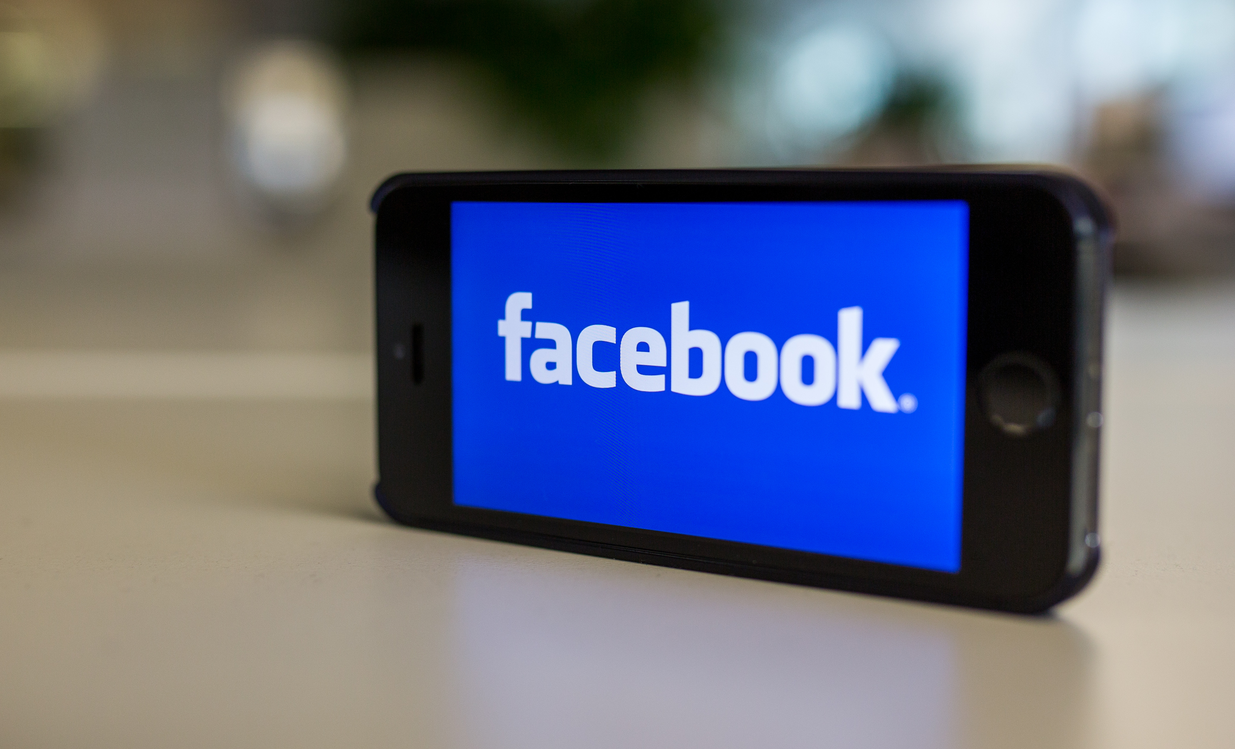 Facebook's logo is pictured on a phone in Berlin, Germany on Oct. 31 2014. (Lukas Schulze—AP)