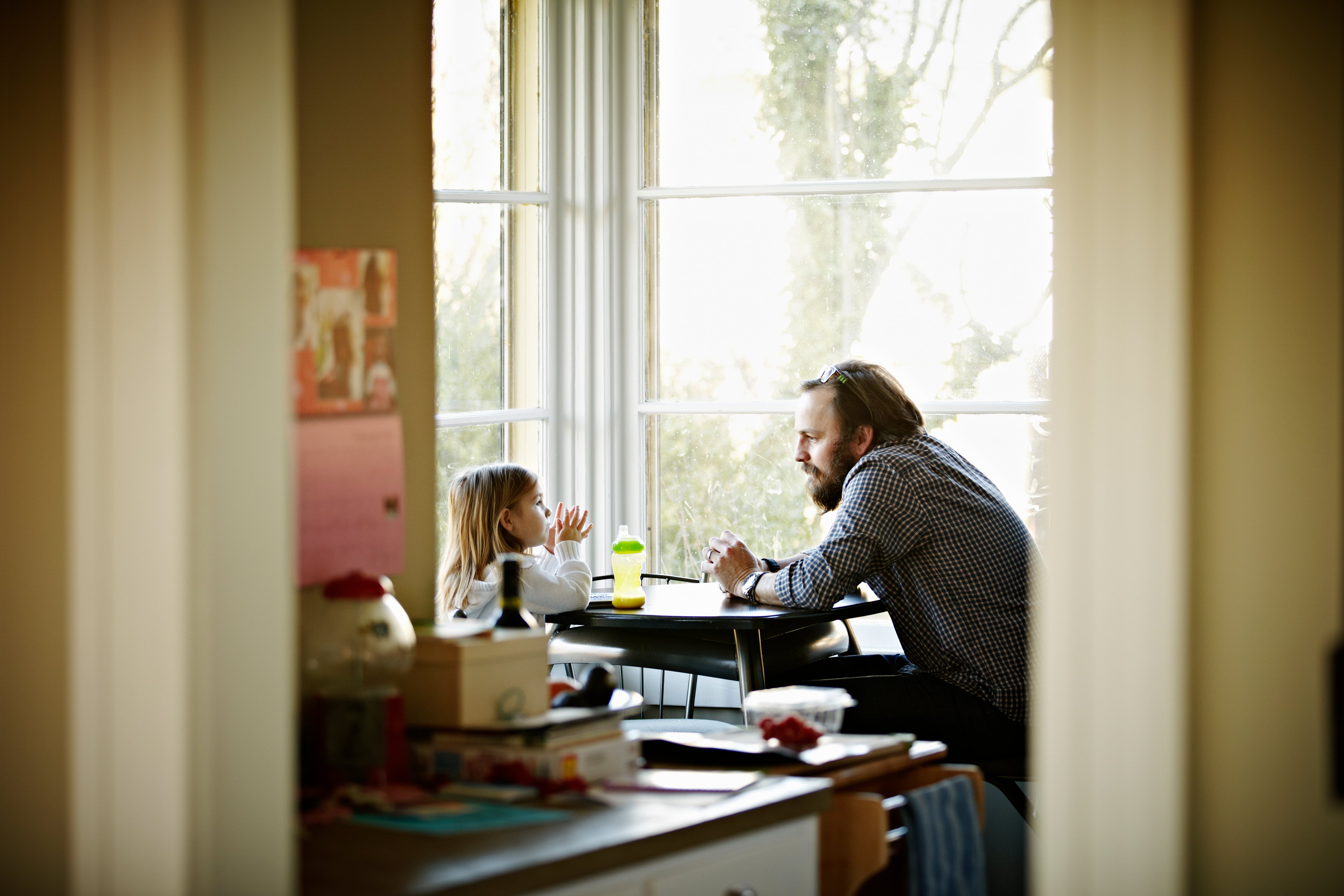 father-daughter-talking-dining-table