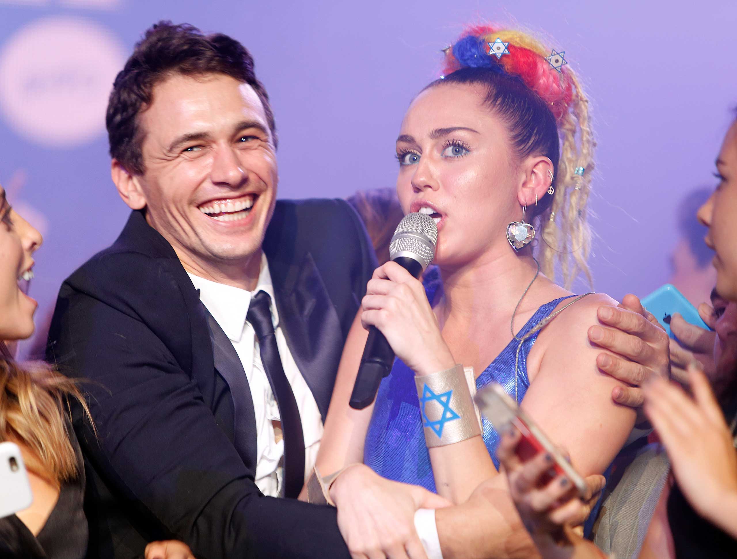 Actor James Franco (L) and musician Miley Cyrus perform onstage during Hilarity for Charity's Annual Variety Show: James Franco's Bar Mitzvah at the Hollywood Palladium in Los Angeles, on Oct. 17, 2015. (Randy Shropshire—Getty Images)
