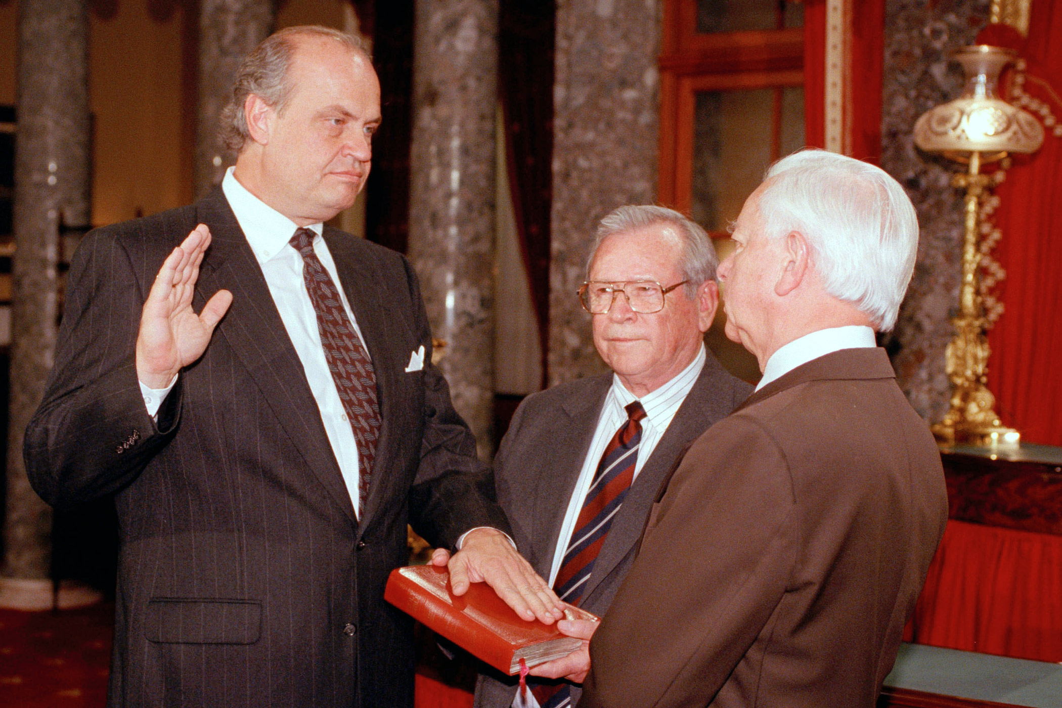 Sen. Fred Thompson (R-Tenn.), left, reenacts taking the Senate oath administered by Senate President Pro Tempore Robert Byrd on Dec. 9, 1994, in the Old Senate Chamber on Capitol Hill.  Former Tennessee Sen. Howard Baker holds the Bible during the ceremony.