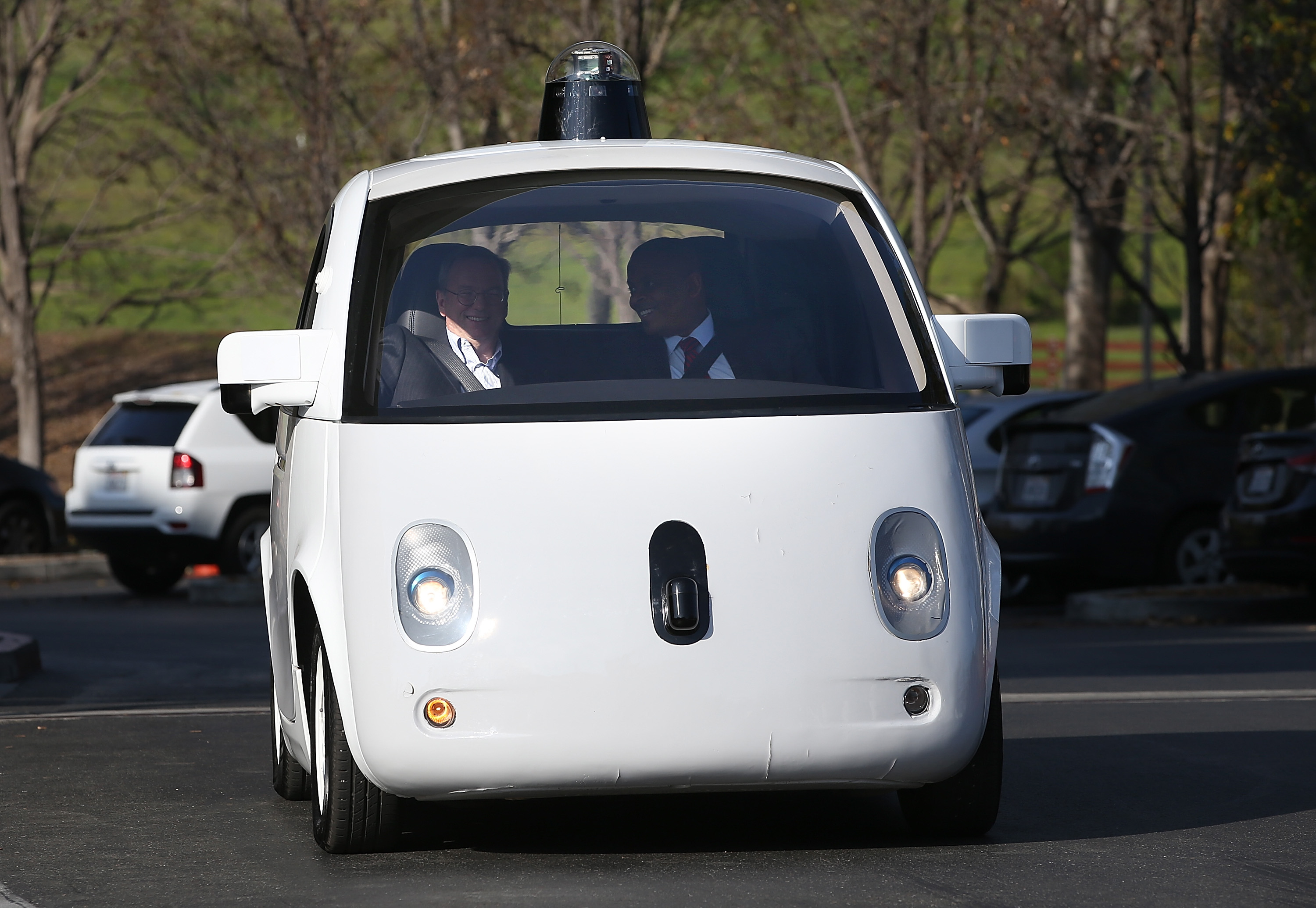 U.S. Transportation Secretary Anthony Foxx (R) and Google Chairman Eric Schmidt (L) ride in a Google self-driving car at the Google headquarters on Feb. 2, 2015 in Mountain View, California.