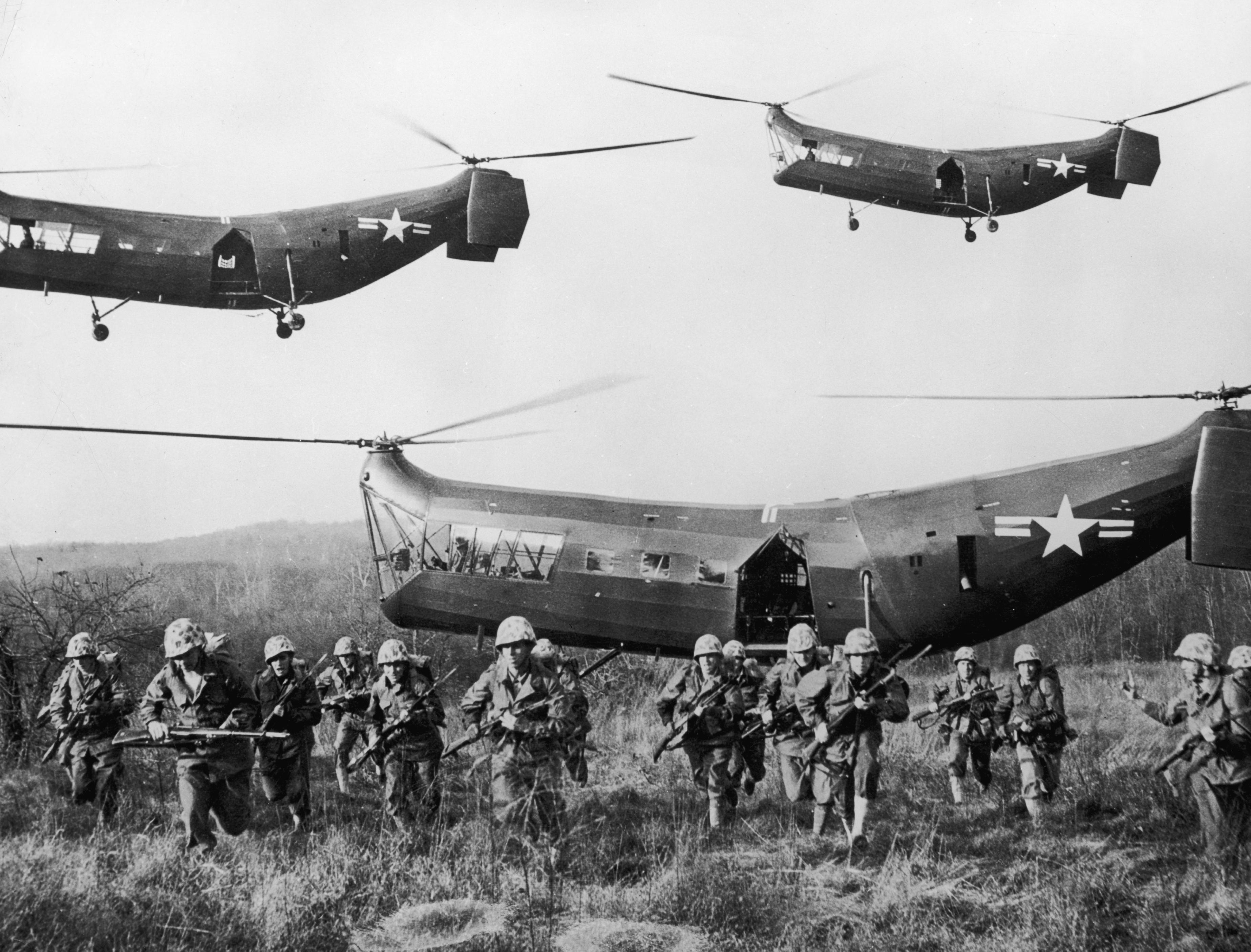 U.S. troops emerge from tandem helicopters onto an open field during the Korean War. (Hulton Archiv—Getty Images)
