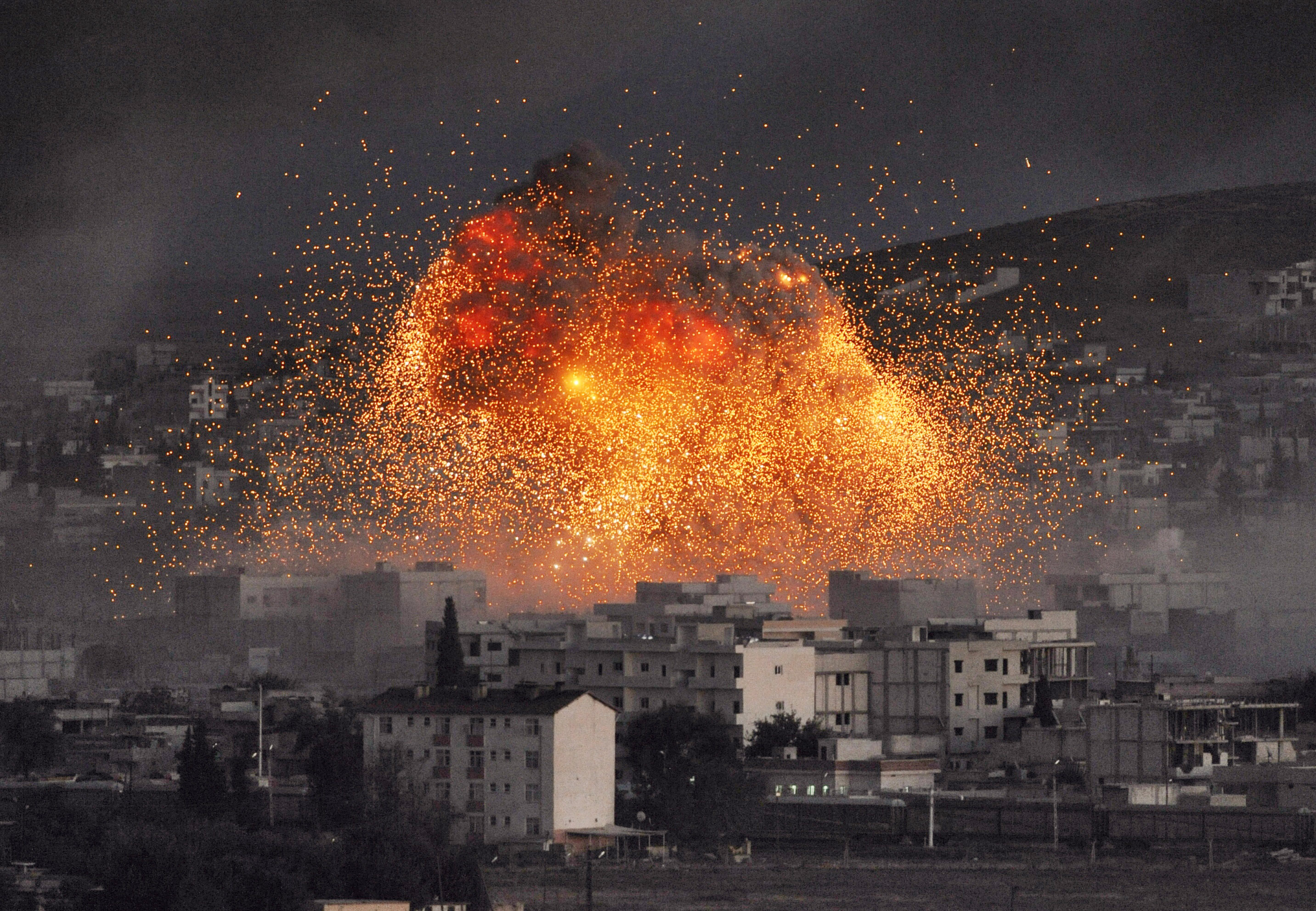 An explosion rocks Syrian city of Kobani during a reported suicide car bomb attack by the militants of Islamic State (ISIS) group on a People's Protection Unit (YPG) position on Oct .20, 2014, in Sanliurfa province, Turkey. (Gokhan Sahin—Getty Images)