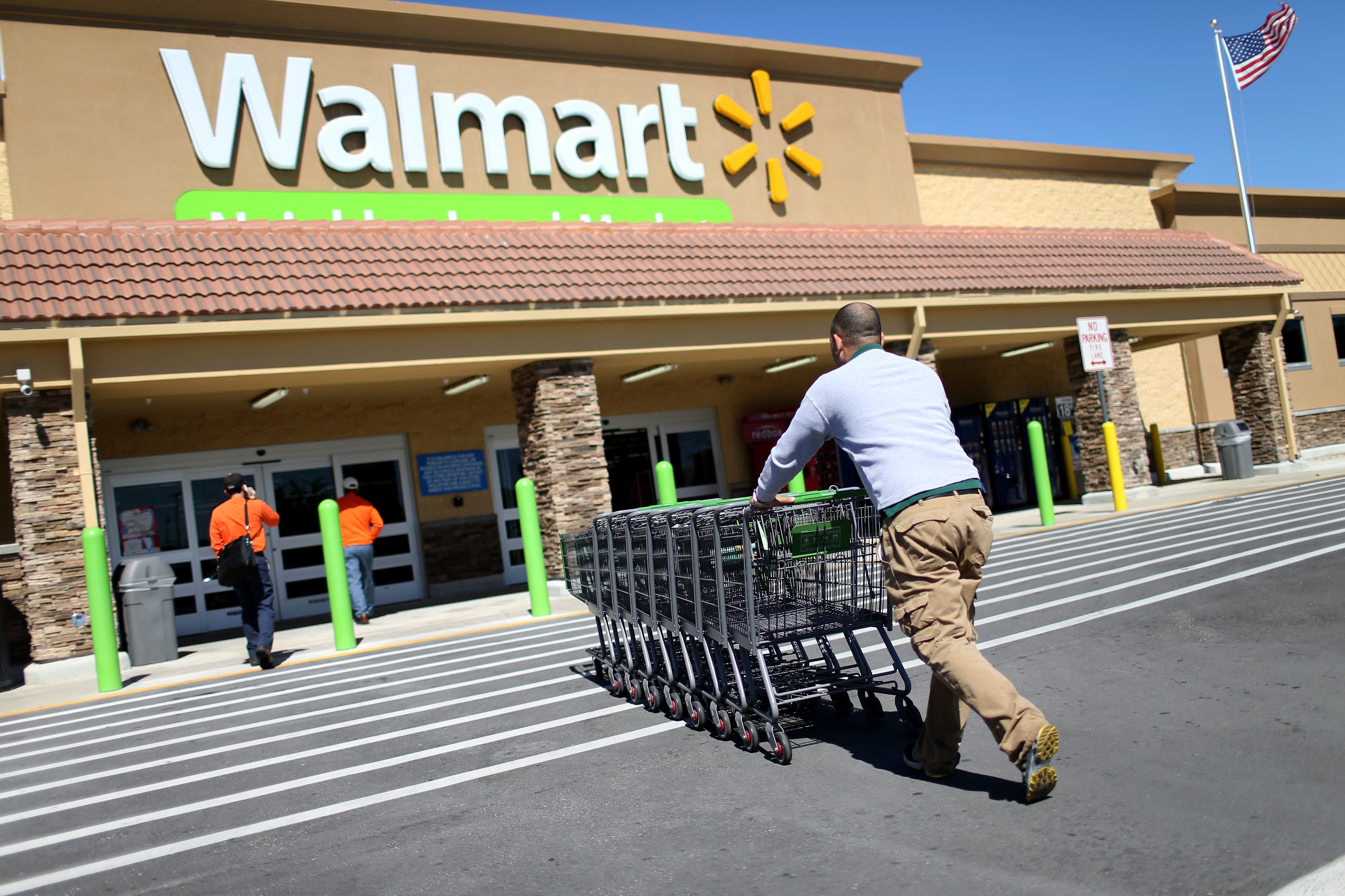 A Walmart employee pushes grocery carts at a Walmart store on February 19, 2015 in Miami, Florida. (Joe Raedle—Getty Images)