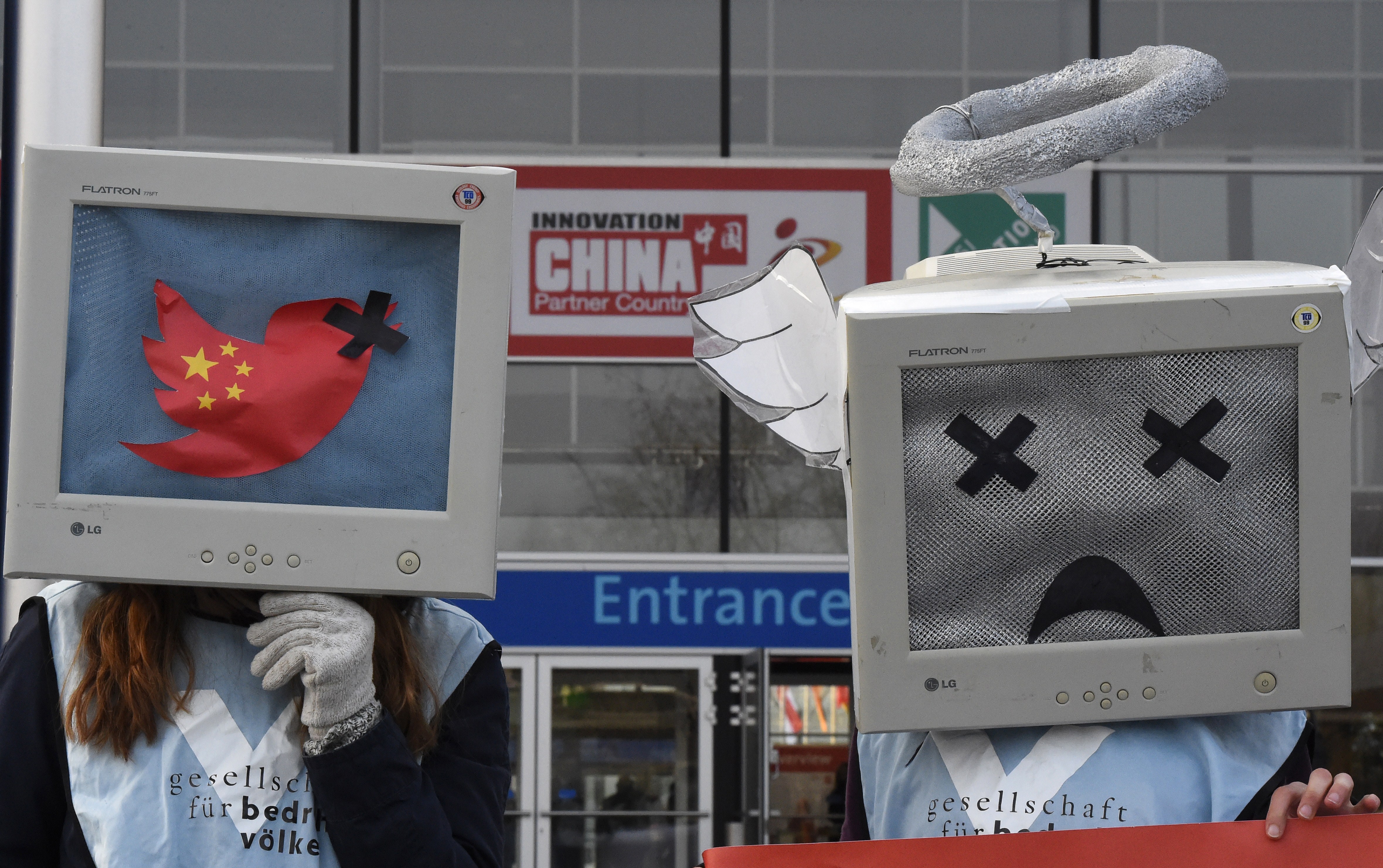Demonstrators protest for freedom of opinion in China during the opening day of the CeBIT technology fair in Hanover, central Germany, on March 16, 2015 (TOBIAS SCHWARZ—AFP/Getty Images)