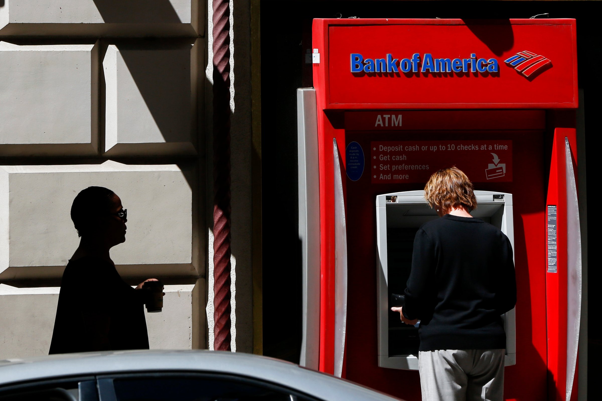 A woman uses a a Bank of America Corp. ATM outside of a branch in Los Angeles, California, U.S., on Monday, July 13, 2015. Photographer: Patrick T. Fallon/Bloomberg