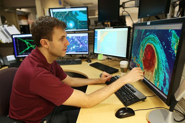 Eric Blake, Hurricane Specialist, uses a computer at the National Hurricane Center to track the path of Hurricane Joaquin. (Joe Raedle&mdash;Getty Images)