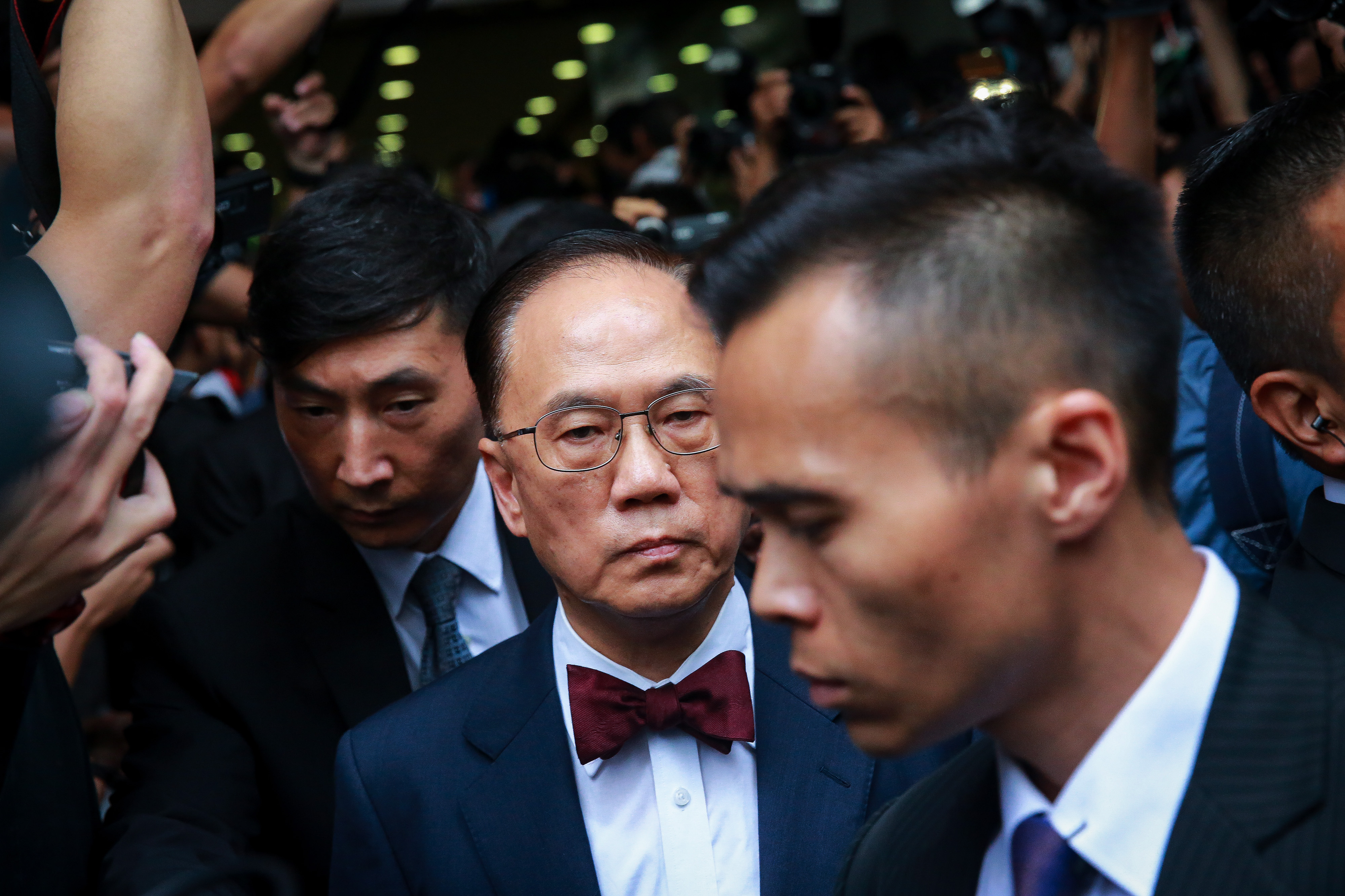 Donald Tsang, Hong Kong's former chief executive, center, leaves the Eastern Law Courts in Hong Kong on  Oct. 5, 2015 (Bloomberg/Getty Images)
