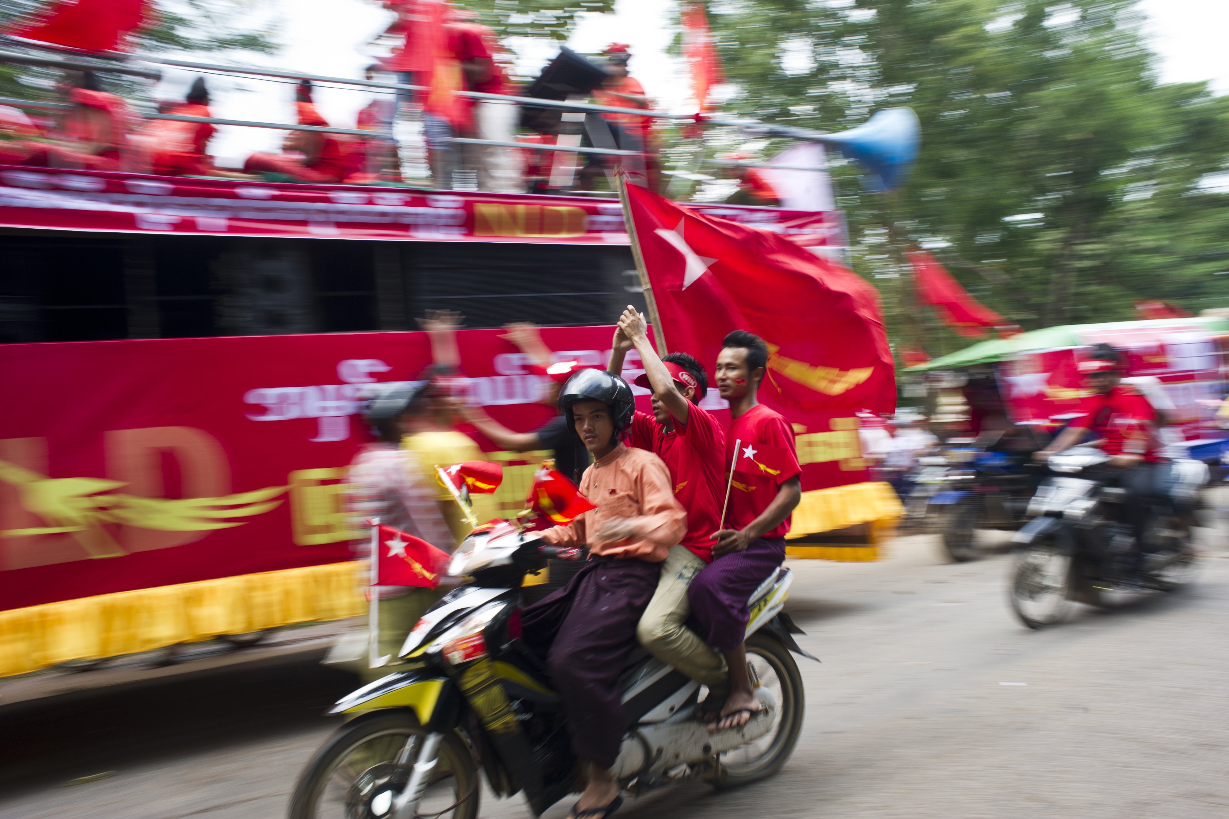Supporters of the National League for Democracy wave flags during a rally ahead of the Nov. 8 general elections in Taikkyi township in northern outskirts of Rangoon on Oct. 10, 2015 (Ye Aung Thu—AFP/Getty Images)